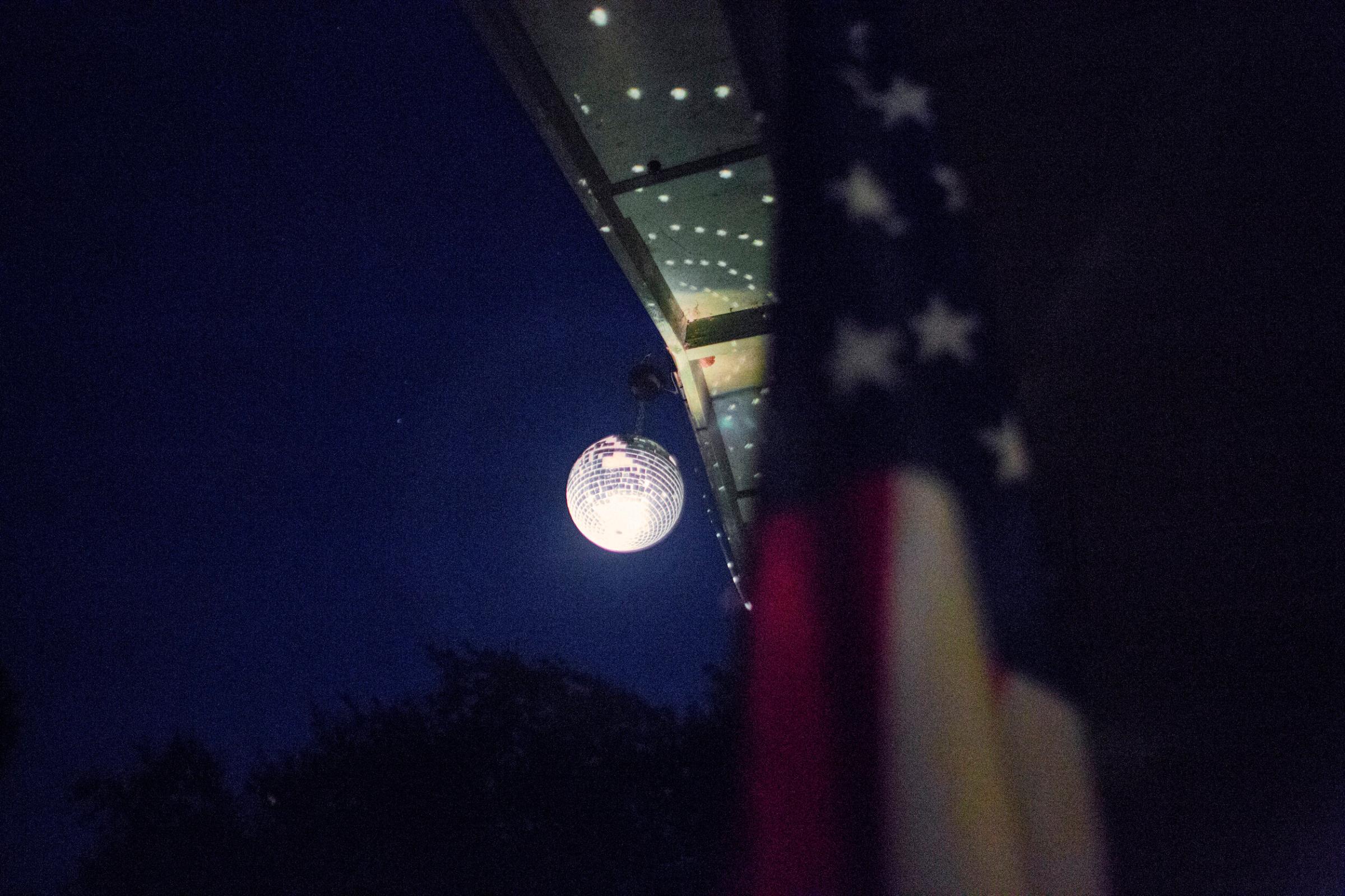 A disco ball and an American flag hang out front of Sister Francis A. Sissy's home, 40 acres...