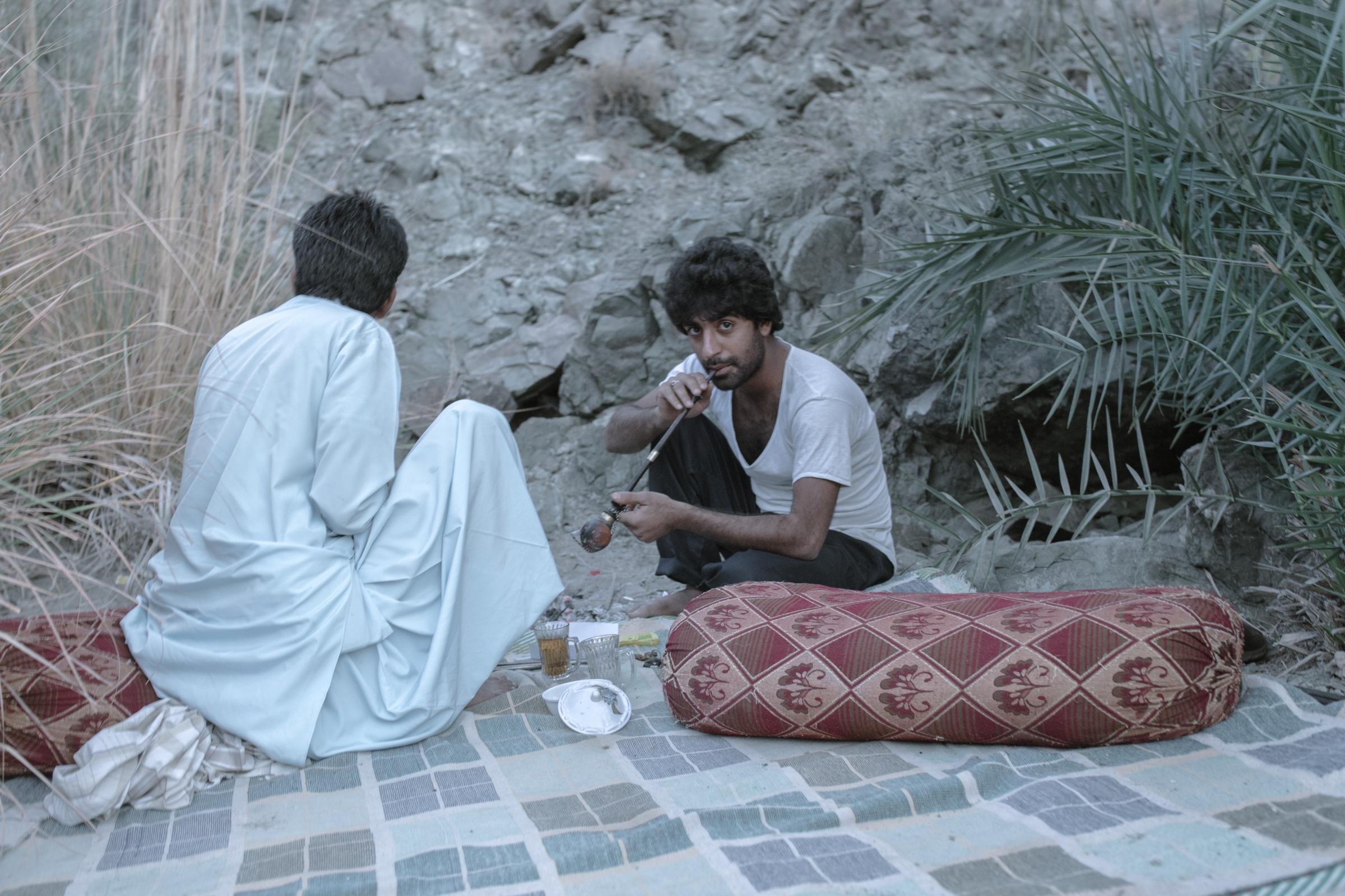 IN THE DESERT OF WETLANDS -   Mahmin  , 24, a father of two, is smoking opium on the...