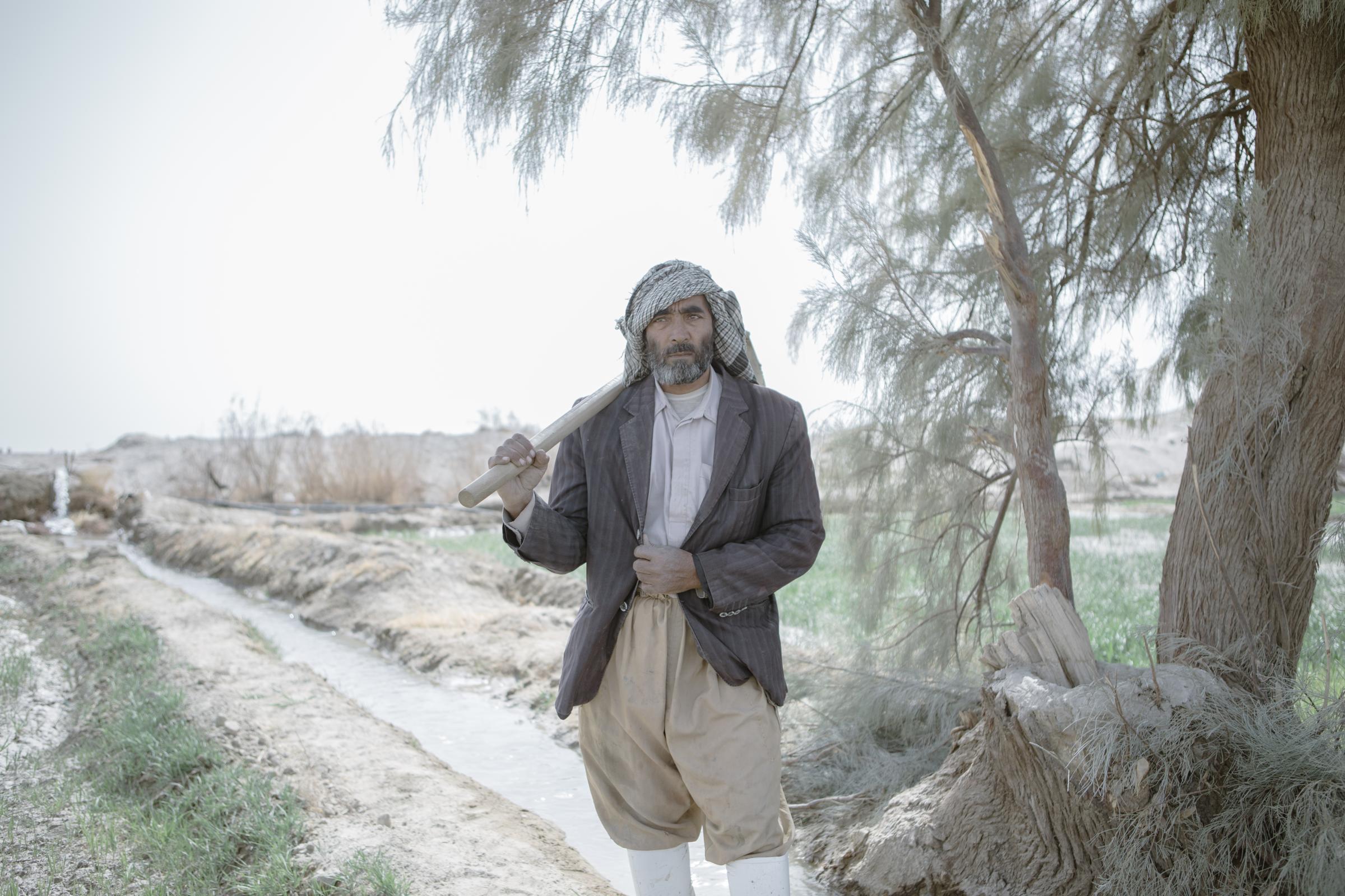 IN THE DESERT OF WETLANDS -   Mohammed,48, is watering his land from a stream of the...