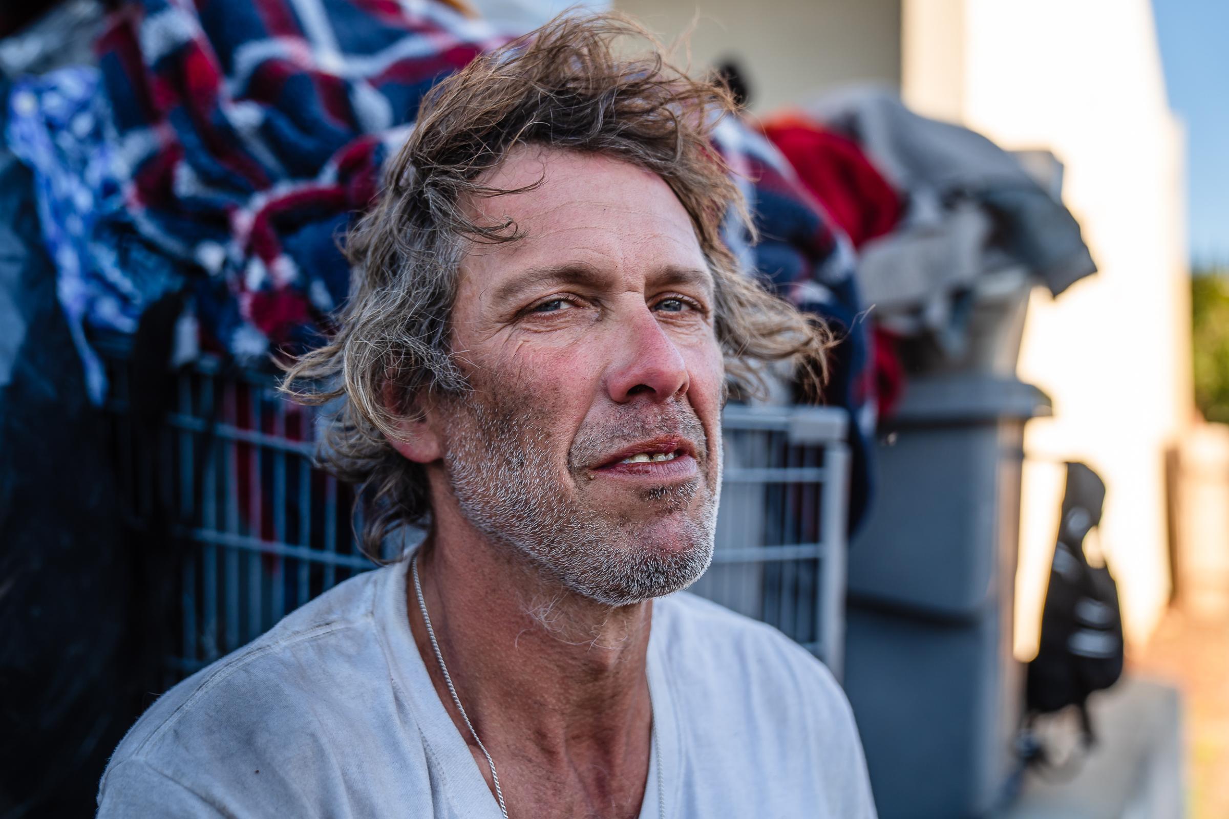  The Faces of Homelessness in San Diego - Josh Nicols, 51, sits in front of a shopping cart with...