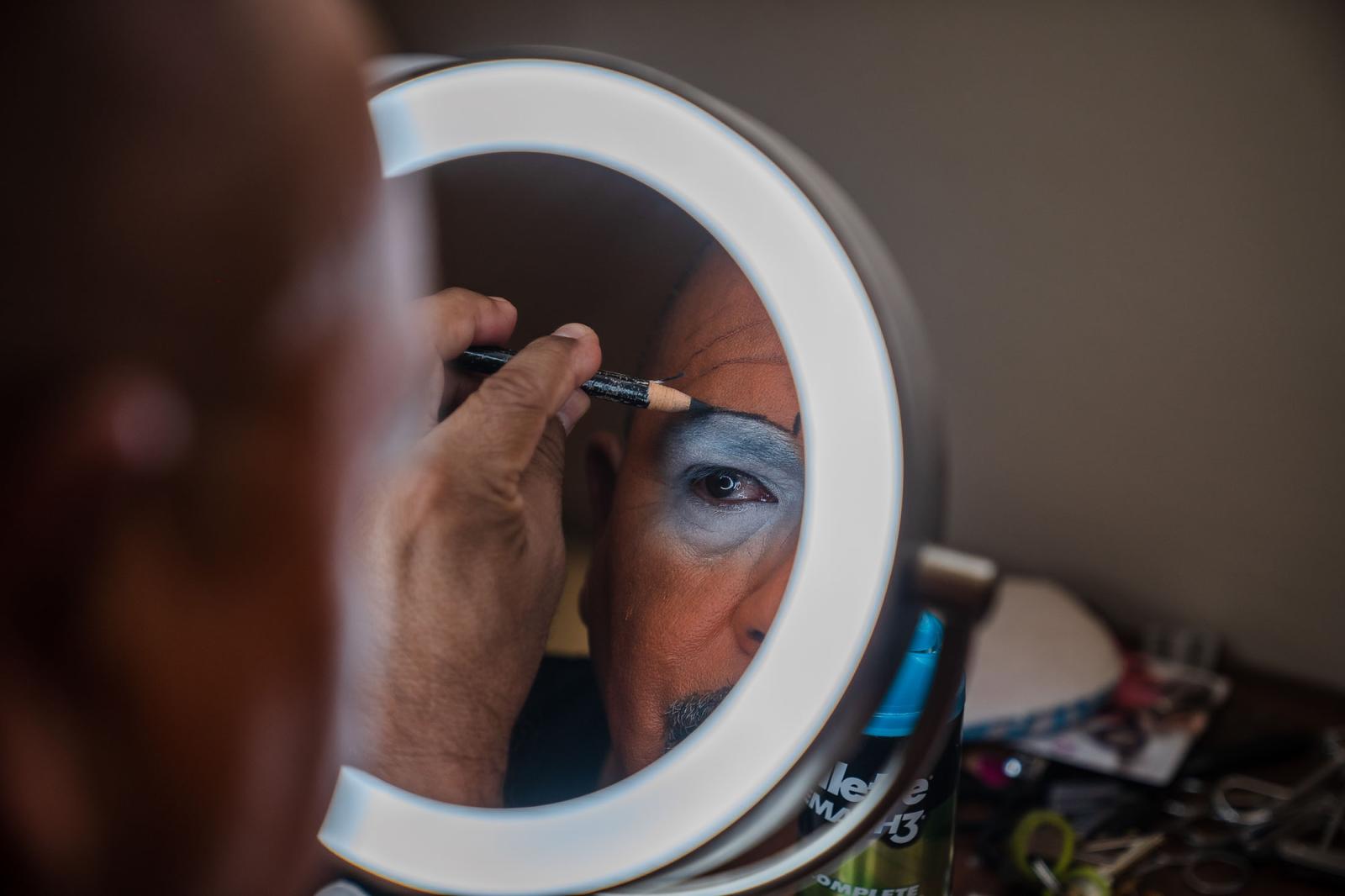 Image from Environmental  - Marco Antonio Alvarado Arragon applies clown make-up...