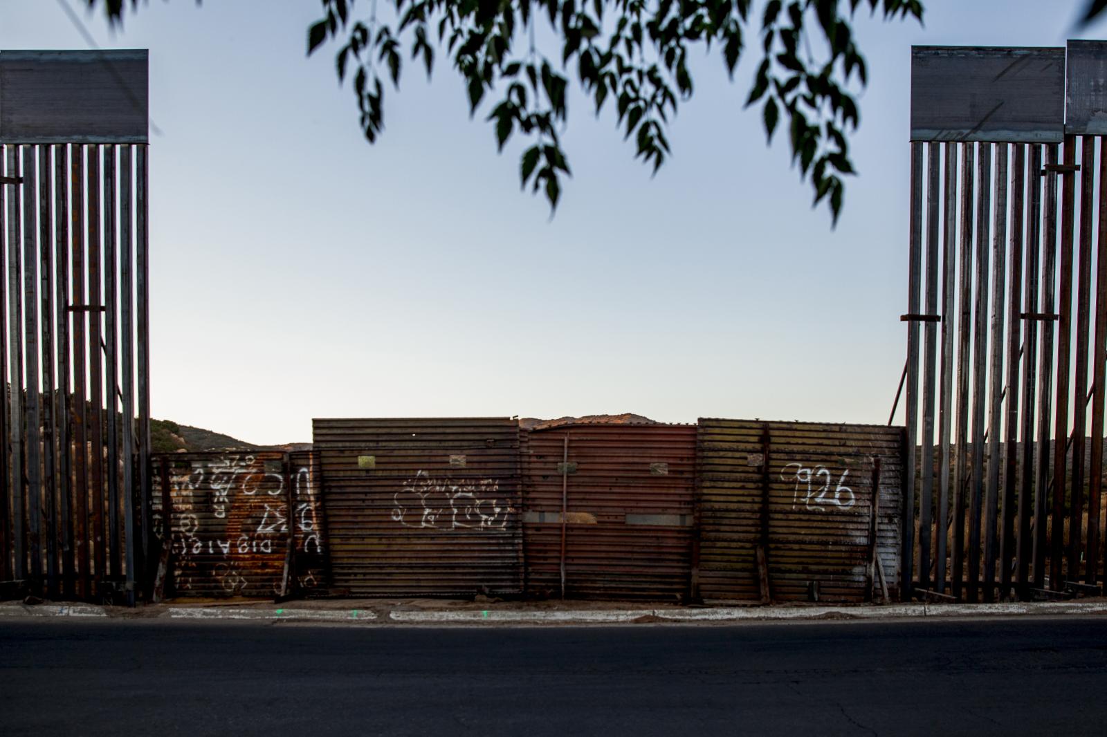 Mexico - A view of the new and old border wall separating the...