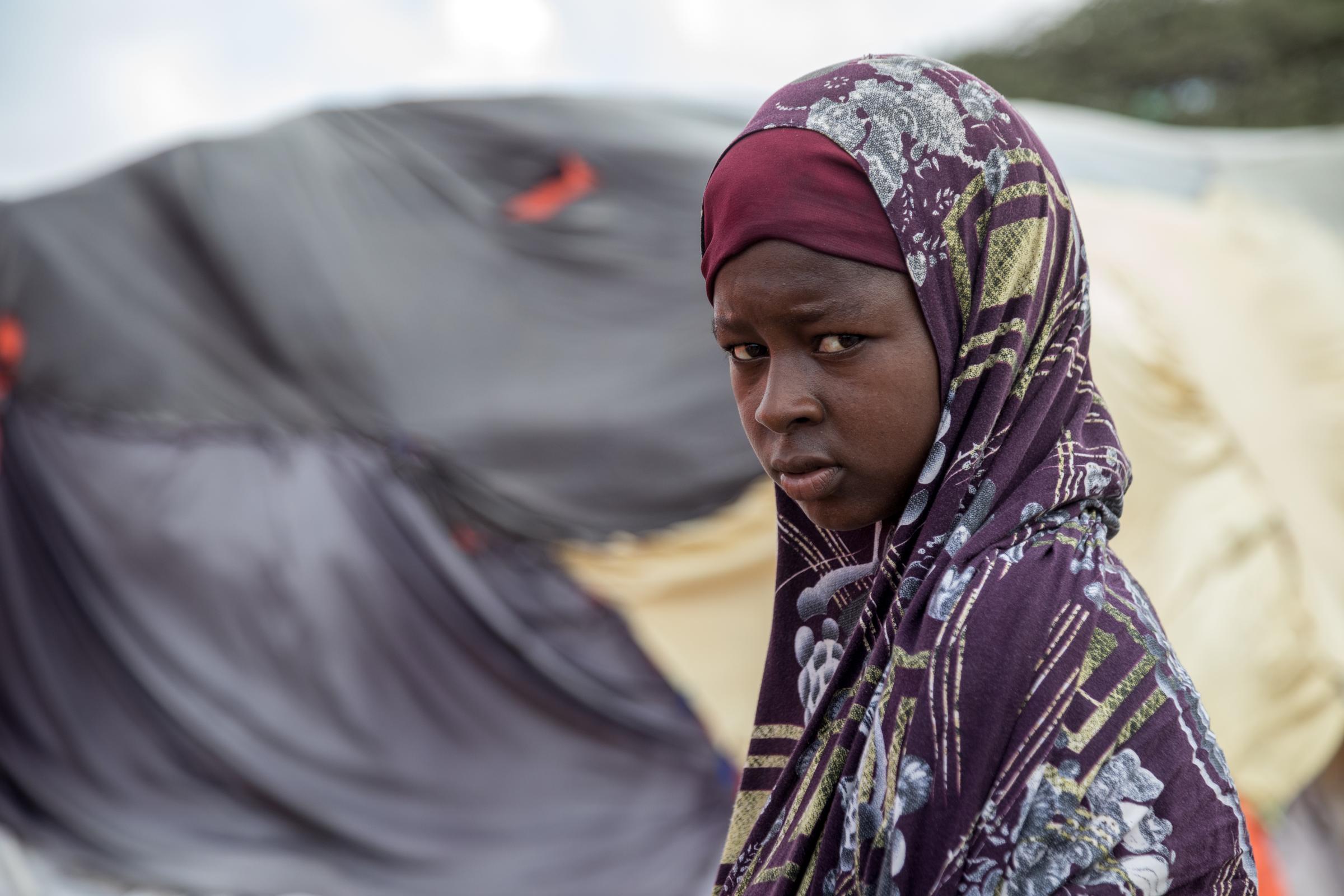Facing the Dual Crisis: A Glimpse into the Lives of Women and Children in Somalia's Kahda District IDP Camp - Rukyo Abbas, an 18-year-old mother of a year and a half-old child, stands on the verge of her...