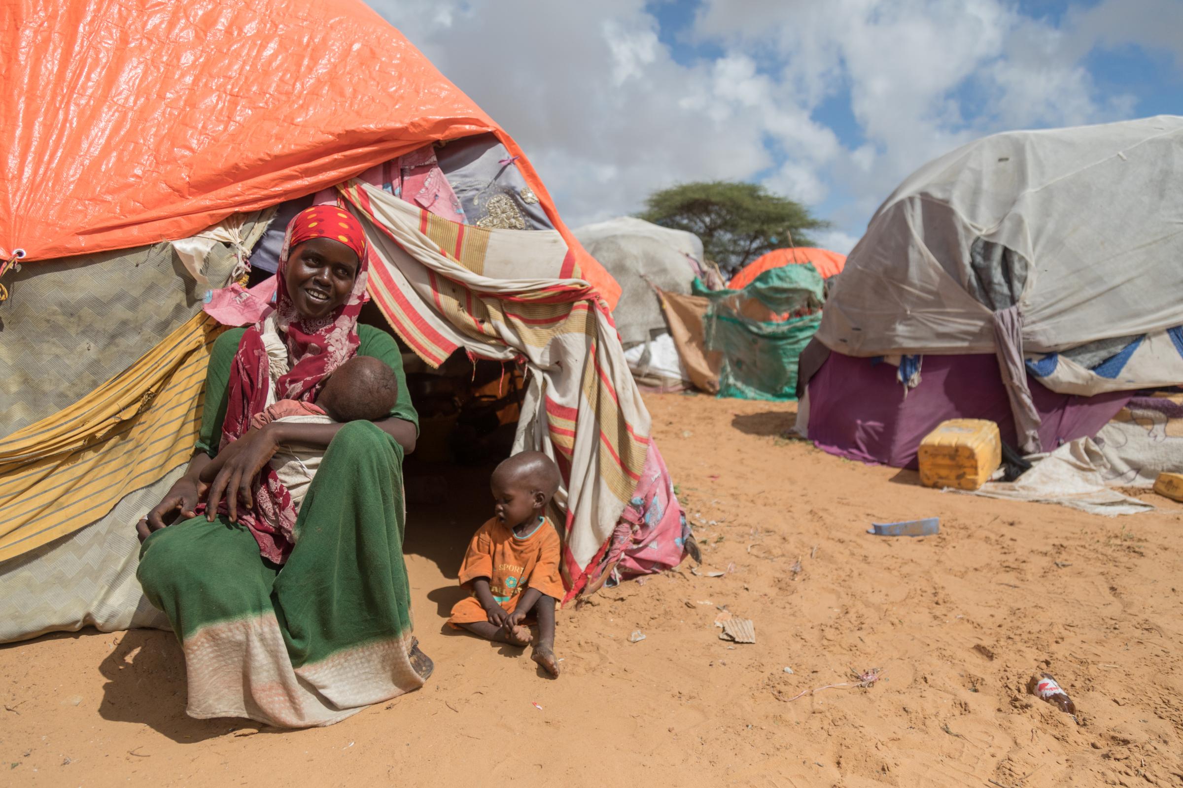 Facing the Dual Crisis: A Glimpse into the Lives of Women and Children in Somalia's Kahda District IDP Camp - Khadio Osman, a resilient mother, fled from the challenges of Lower Shabelle in search of safety...