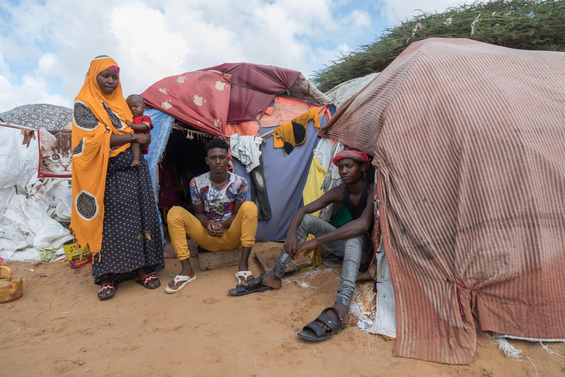 Facing the Dual Crisis: A Glimpse into the Lives of Women and Children in Somalia's Kahda District IDP Camp - Saleban, Abdi, both 20 years old, and Saleban&#39;s wife Amina, 18 years old, finding refuge...