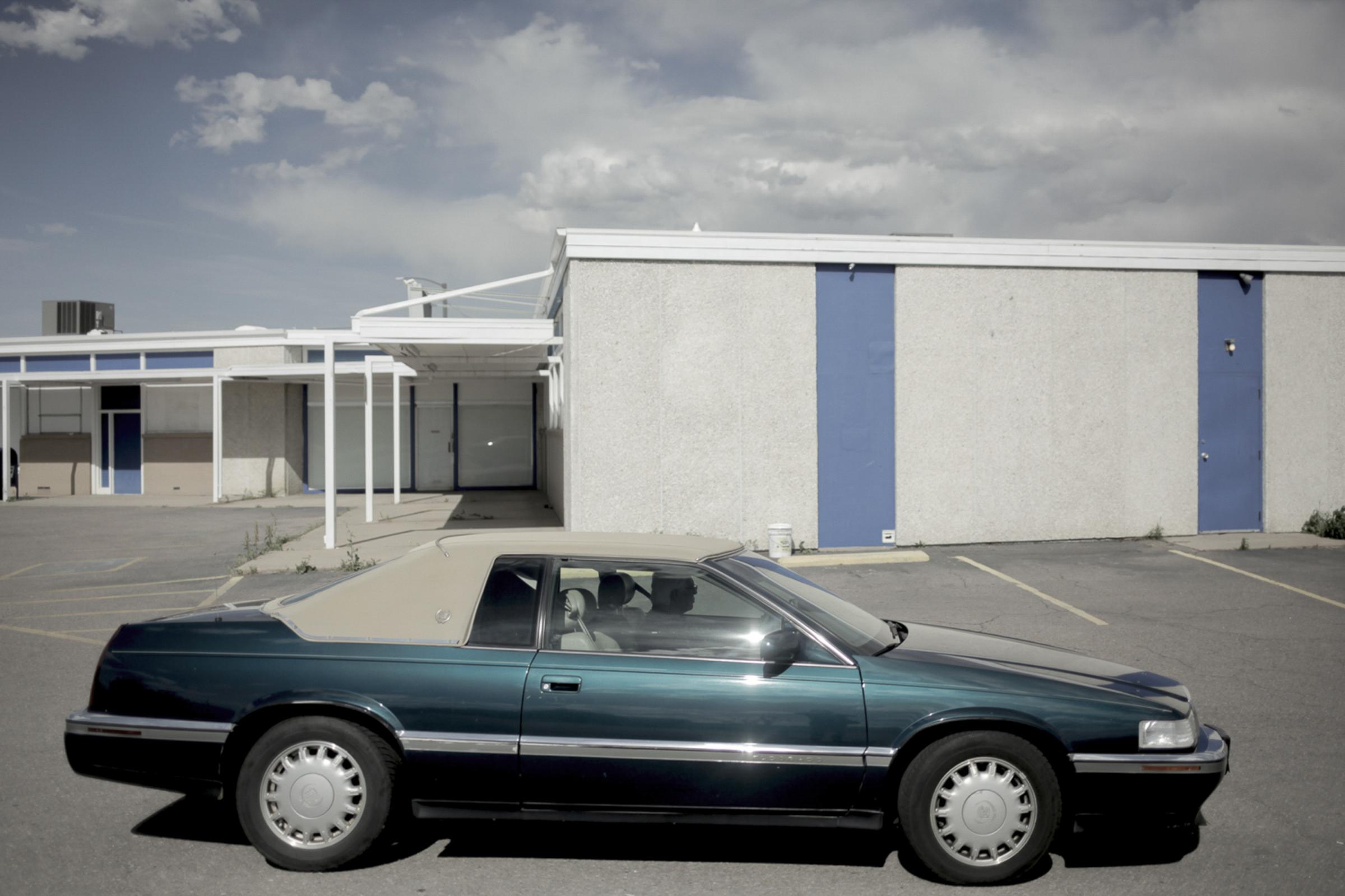 COLFAX AVE - A vacant parking lot within an abandoned strip mall in...