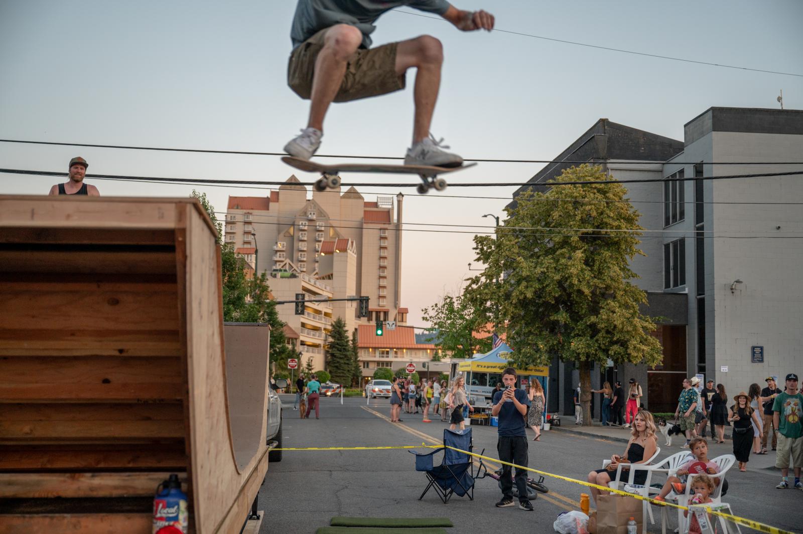 A skater jumps of a halfpipe in...block party in downtown Coeur d