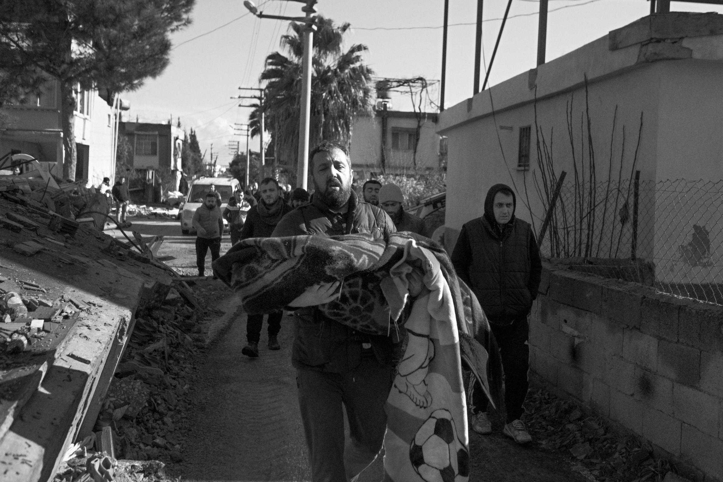 Earthquake in Turkey (2023) - Bashar carries Zaid's body to the ambulance. His...