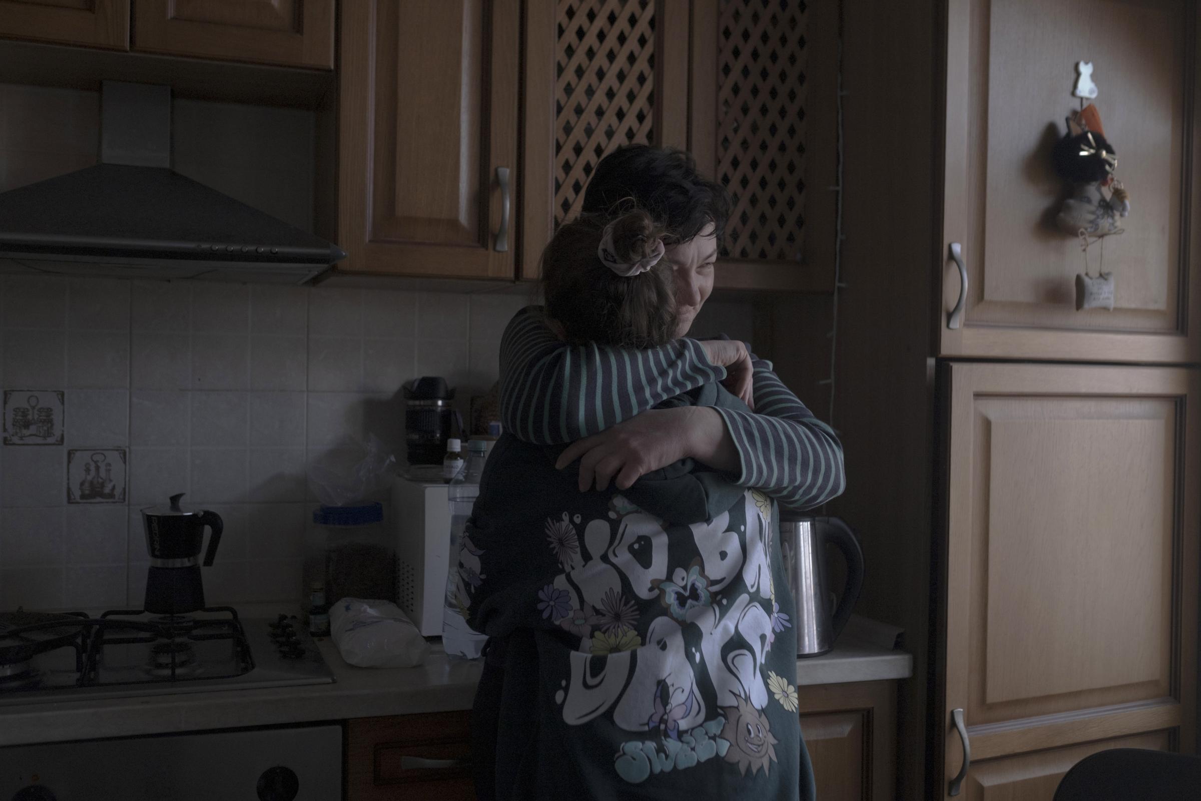 Moldovans who sheltered Ukrainian refugees at home - Olga is hugging Liza.