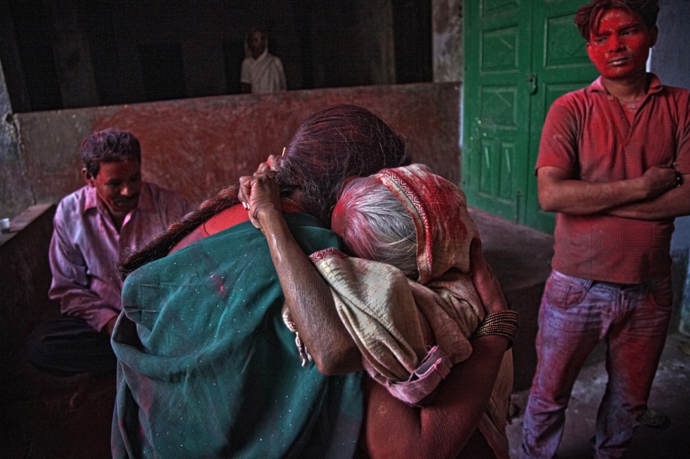 Path breaking move - A widow in tears hugs a woman at the end of the day long...