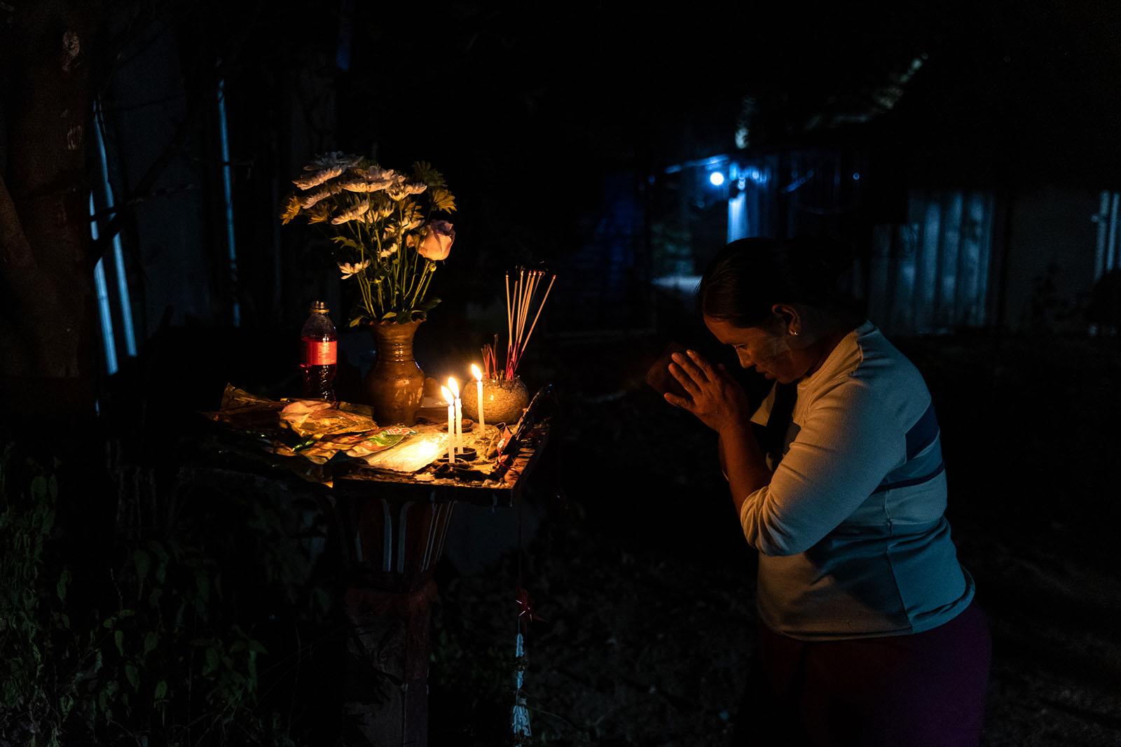 LIFE ON THE OTHER SIDE - Chiang Rai - Migrant worker Thin Thin Maw, 37, prays at a...