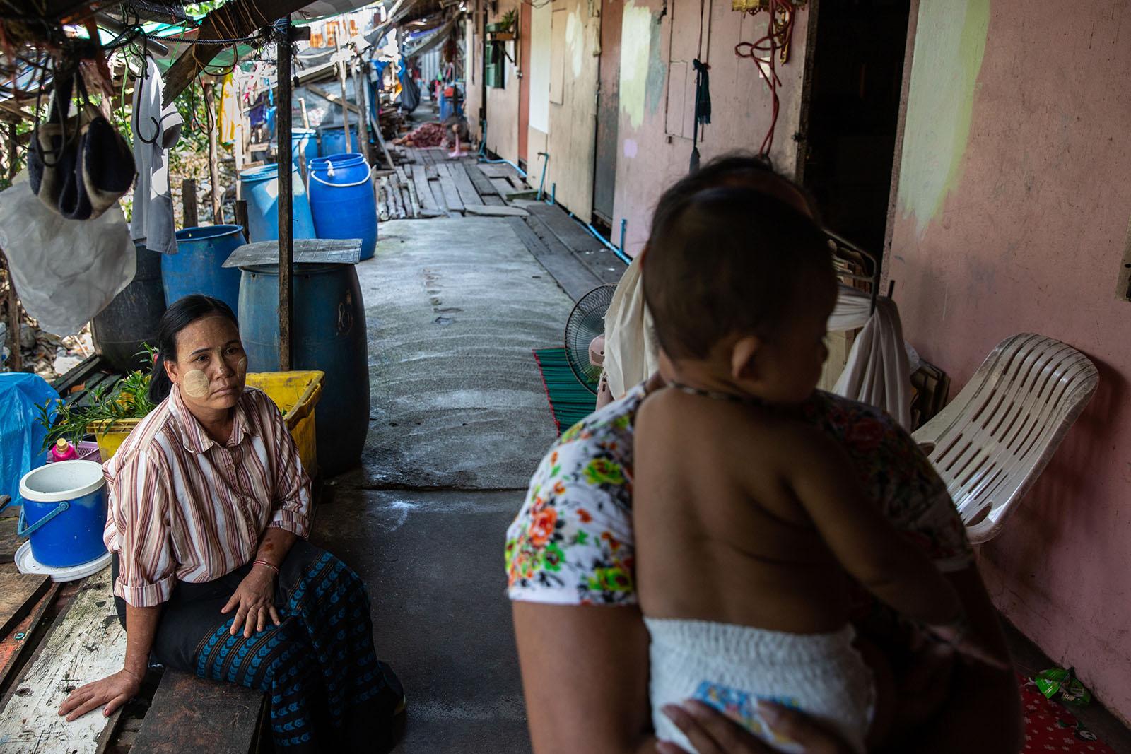 LIFE ON THE OTHER SIDE - Phuket - A women from Myanmar sits outside her one-room...