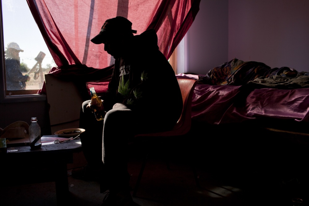 A man prepares to smoke Marijua...ion of life for many Barkindji.