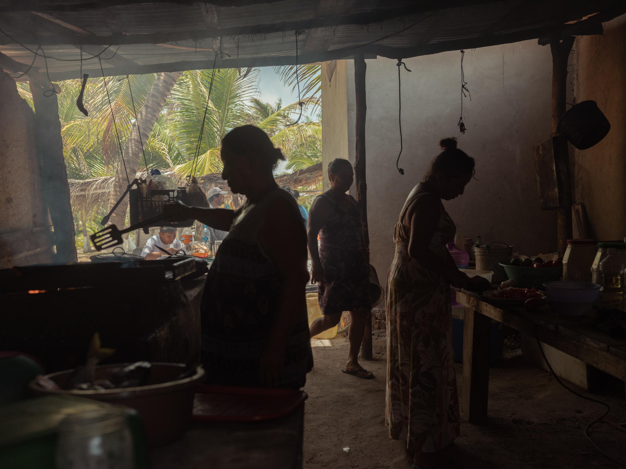 The Changing Wave - Women prepare a meal with the day's catch in the Sian...