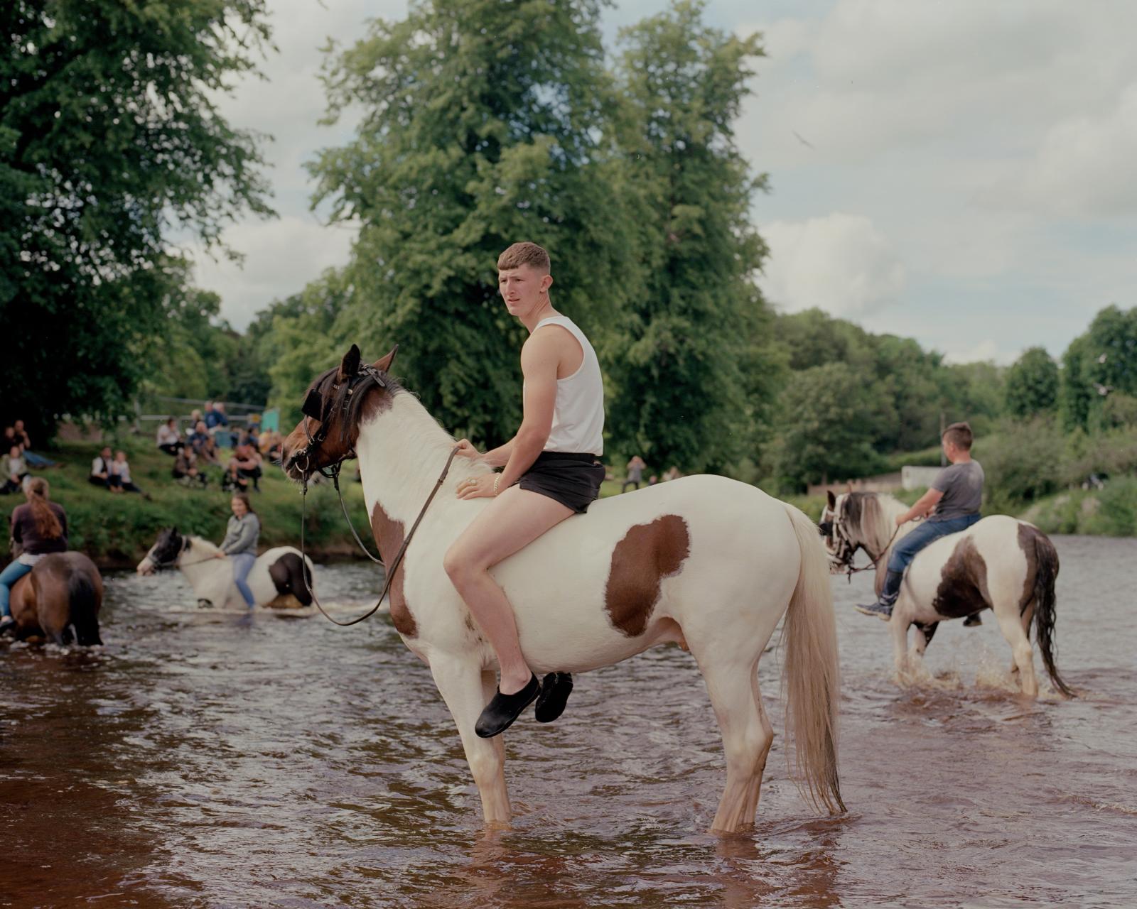 A boy in River Eden, Appleby Fair. England, 2019.