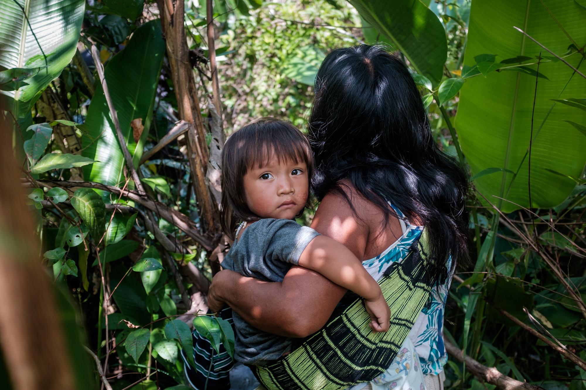 A Ka'apor woman and her child on a fishing expedition in the newly occupied and heavily deforested area of their indigenous territory in the...