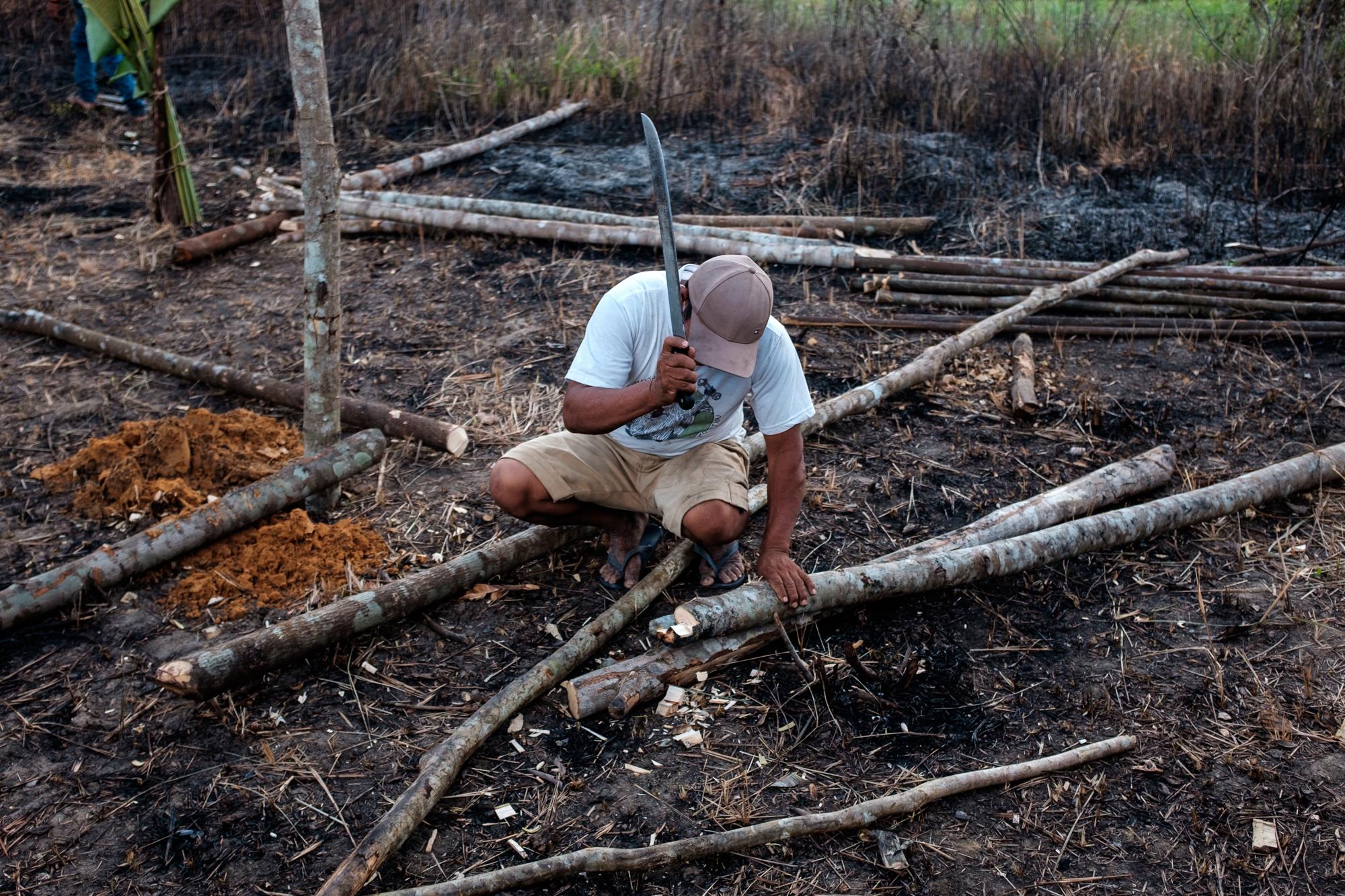 The Last Forest - A member of the Ka'apor Self-Defence Guard cuts wood for...