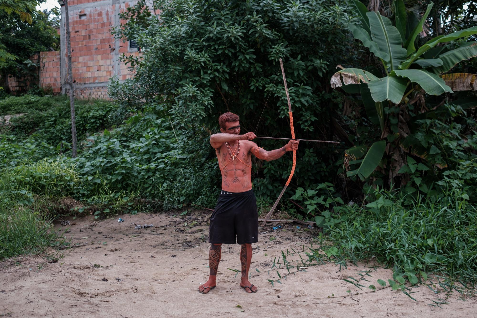 We Were Always Here - Alcer Albuquerque Kokama, 31, practices with his bow and...