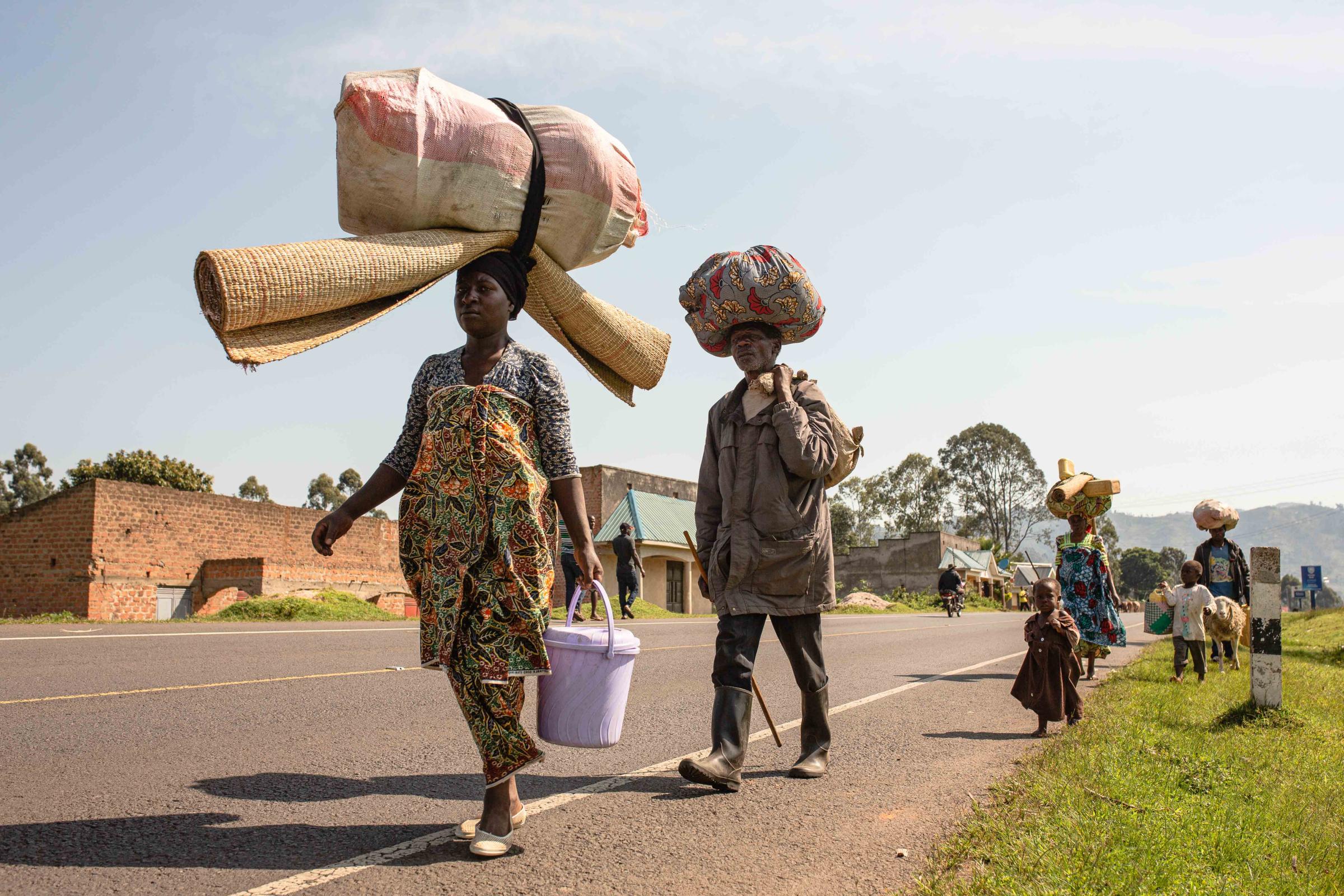 Commissioned Works - Families walk back to DRC from one of the Asylum...