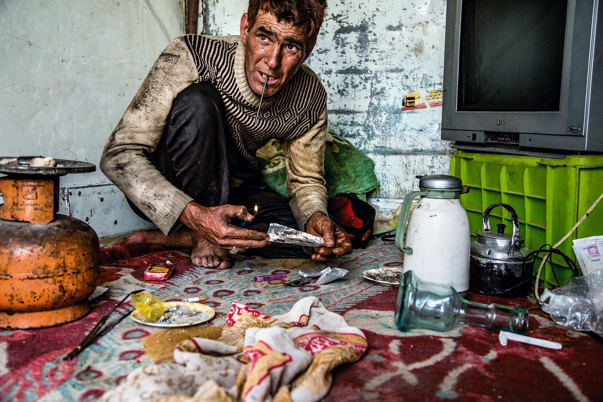 The last & lost nomades of Iran - Ahmad at work, smoking heroin. “I’d like to give it up....