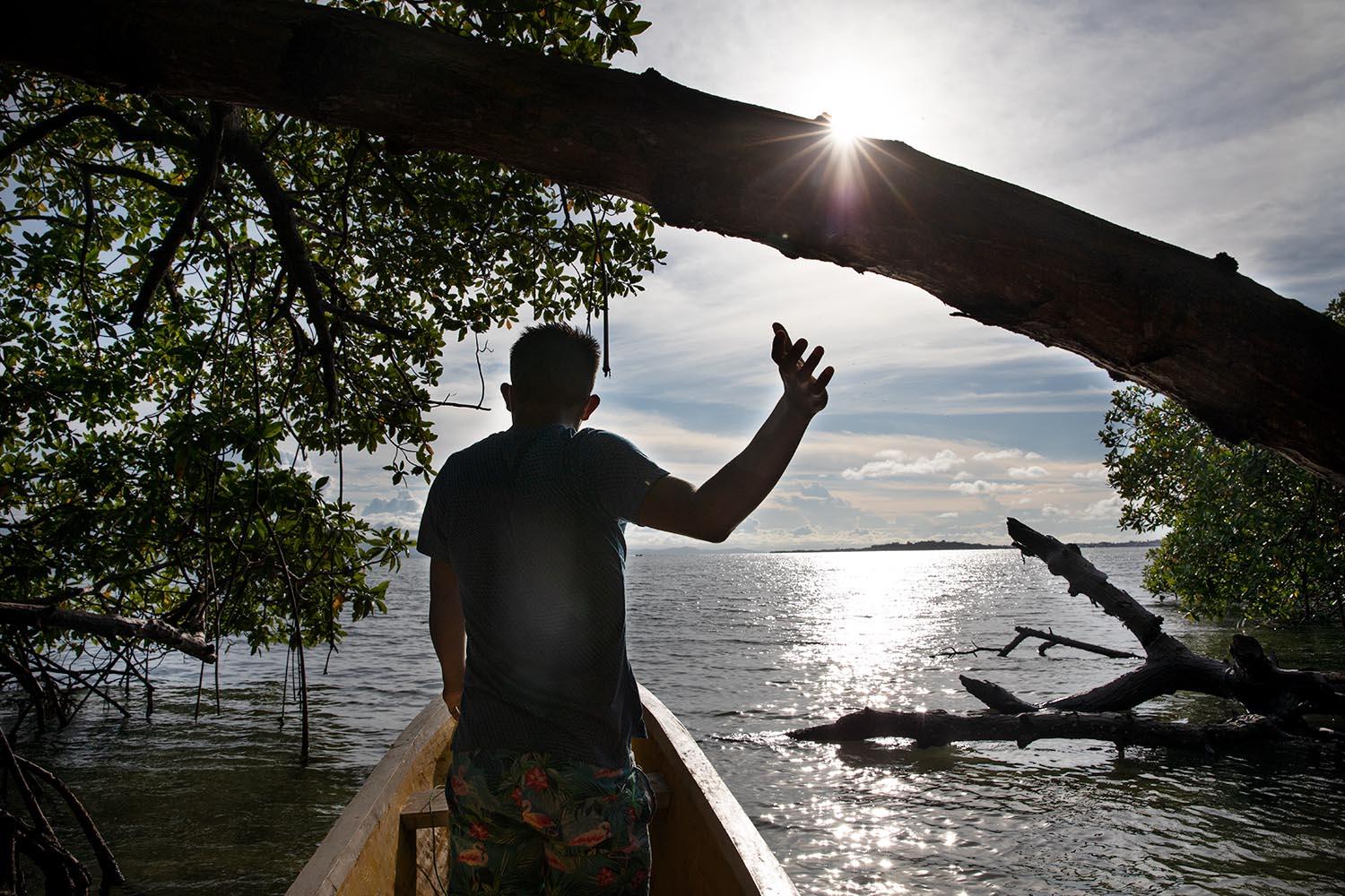 Beyond blue water - Young Ngäbe man sailing to fish. Solarte Island....