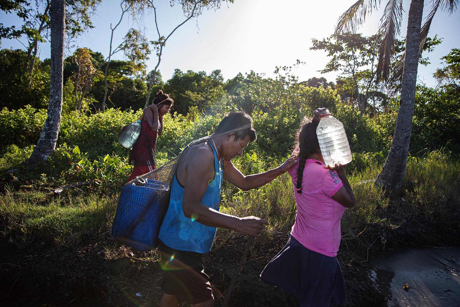 Beyond blue water - Ngäbe Indigenous women collecting drinkable water...