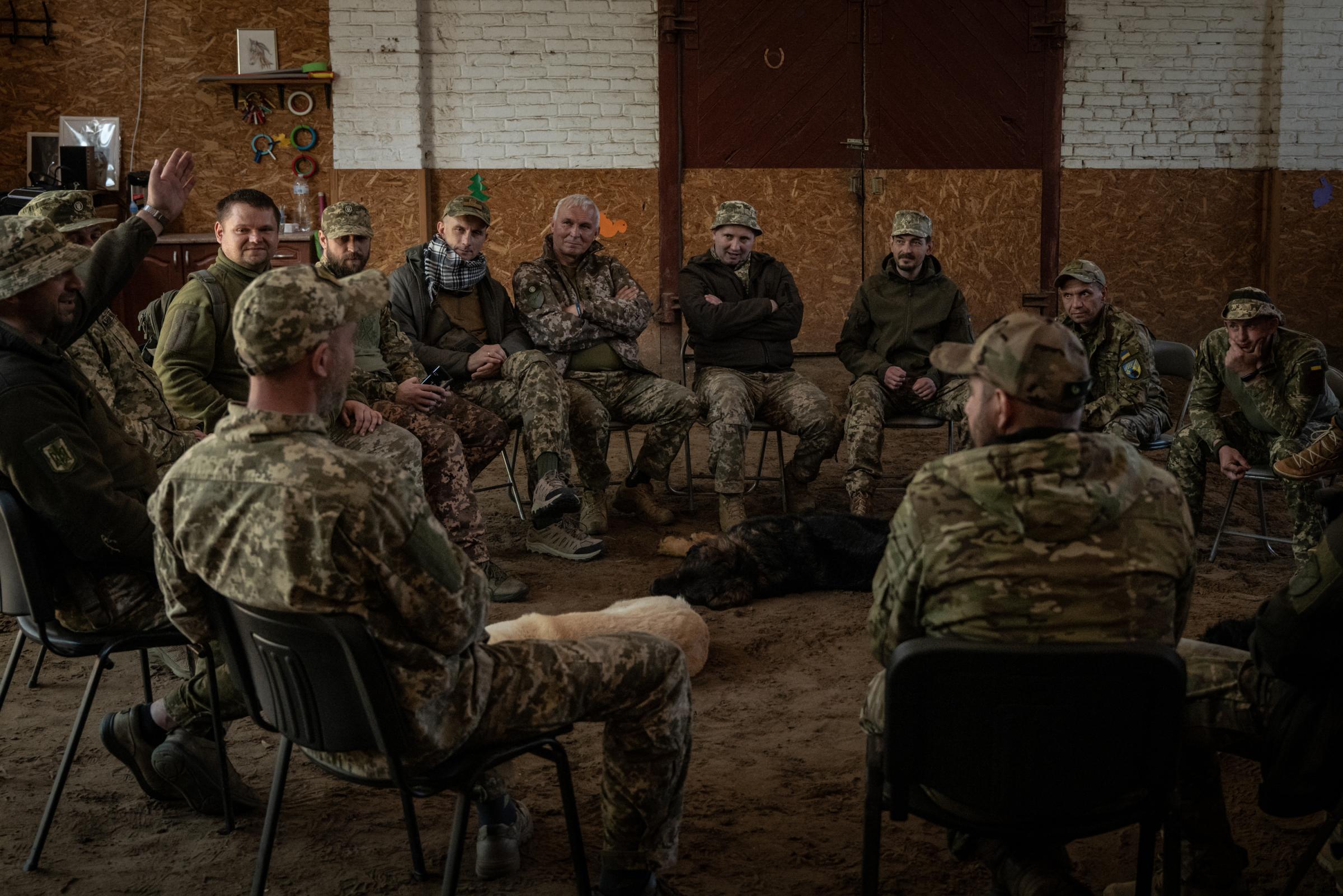 The Hidden Trauma of Ukraine's Soldiers - Ukrainian soldiers sat in a circle as part of their group...