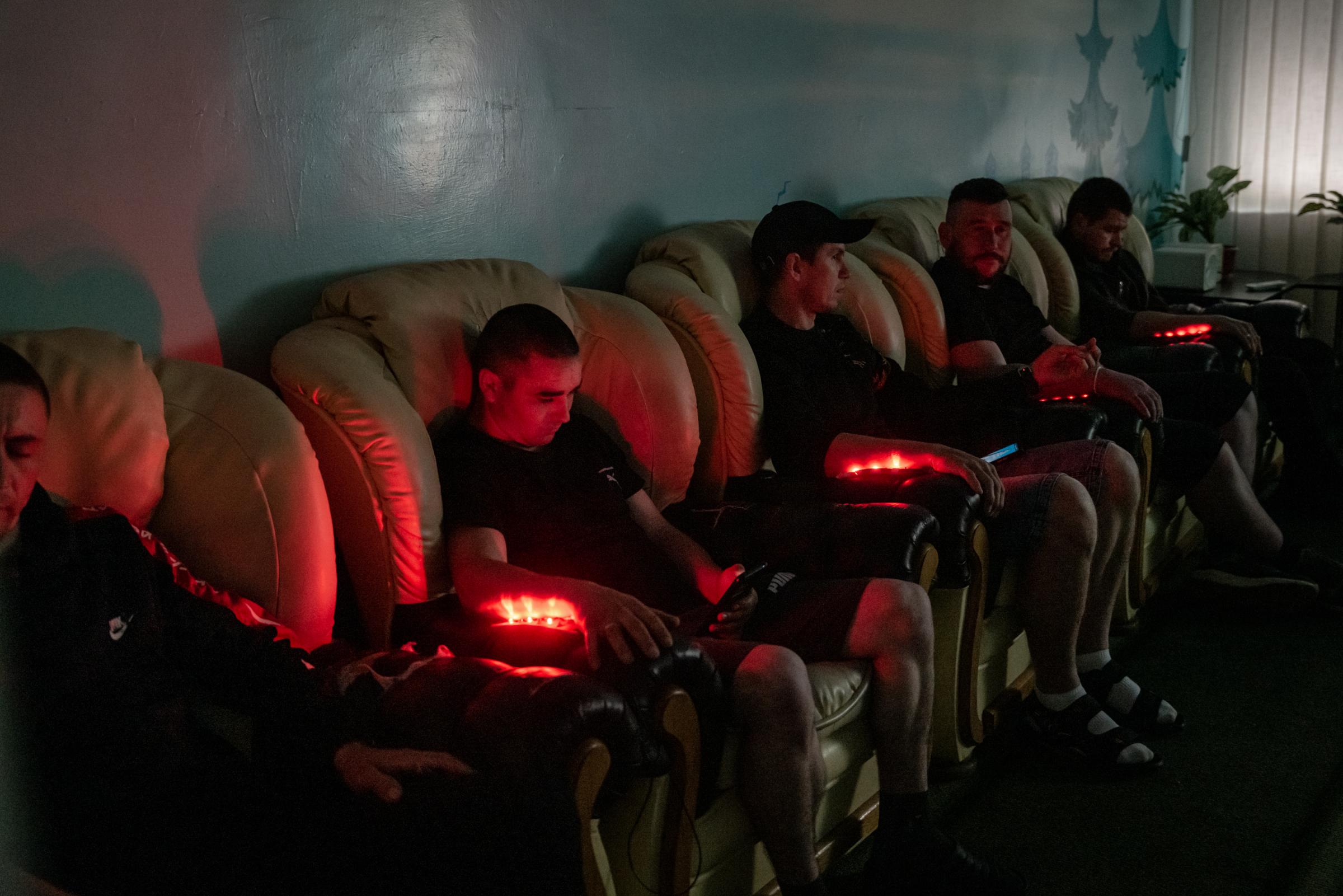 The Hidden Trauma of Ukraine's Soldiers - Ukrainian soldiers sat in a room while receiving laser...