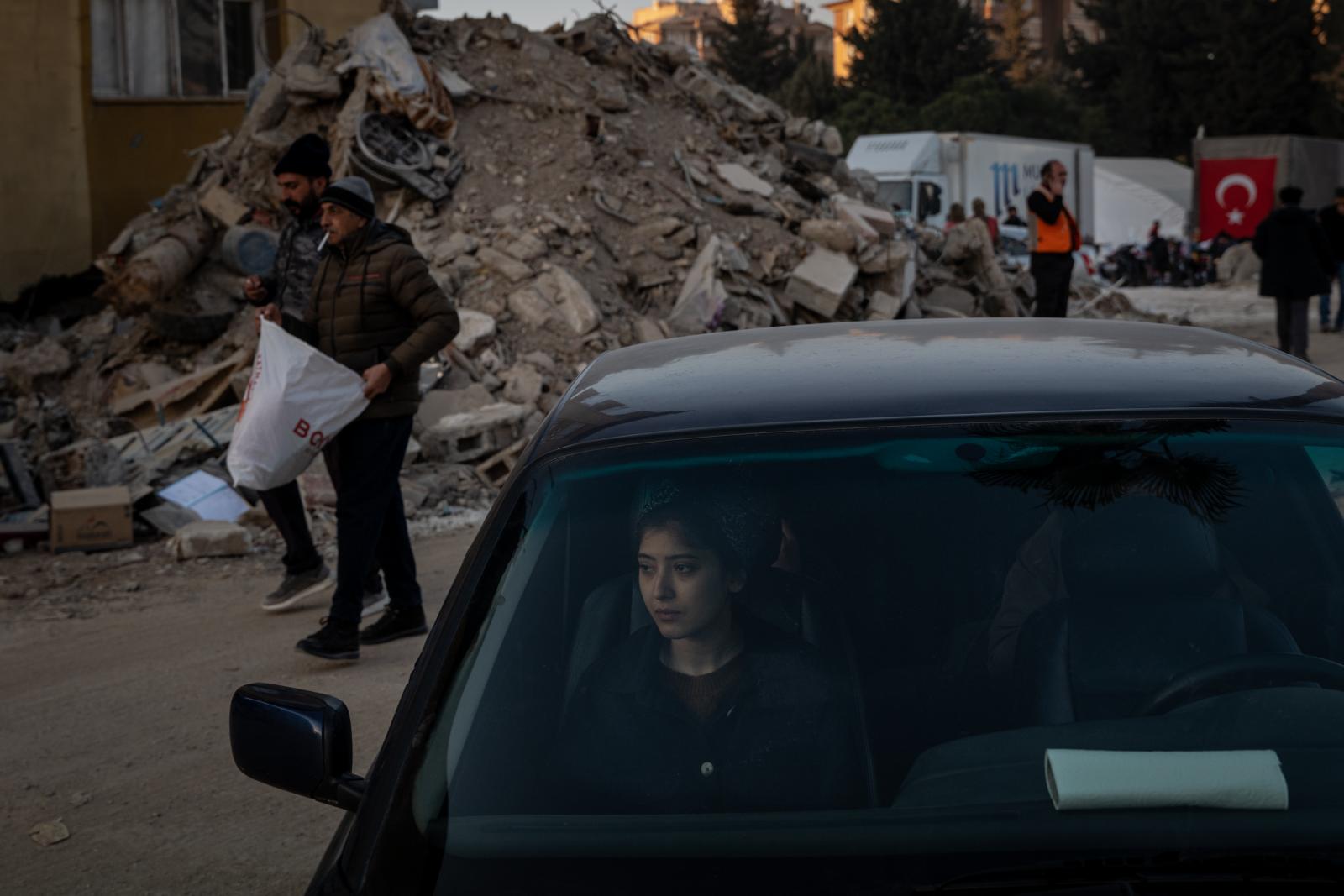 The Tremble of the Earth - A woman looked on amid the devastation of Antakya,...