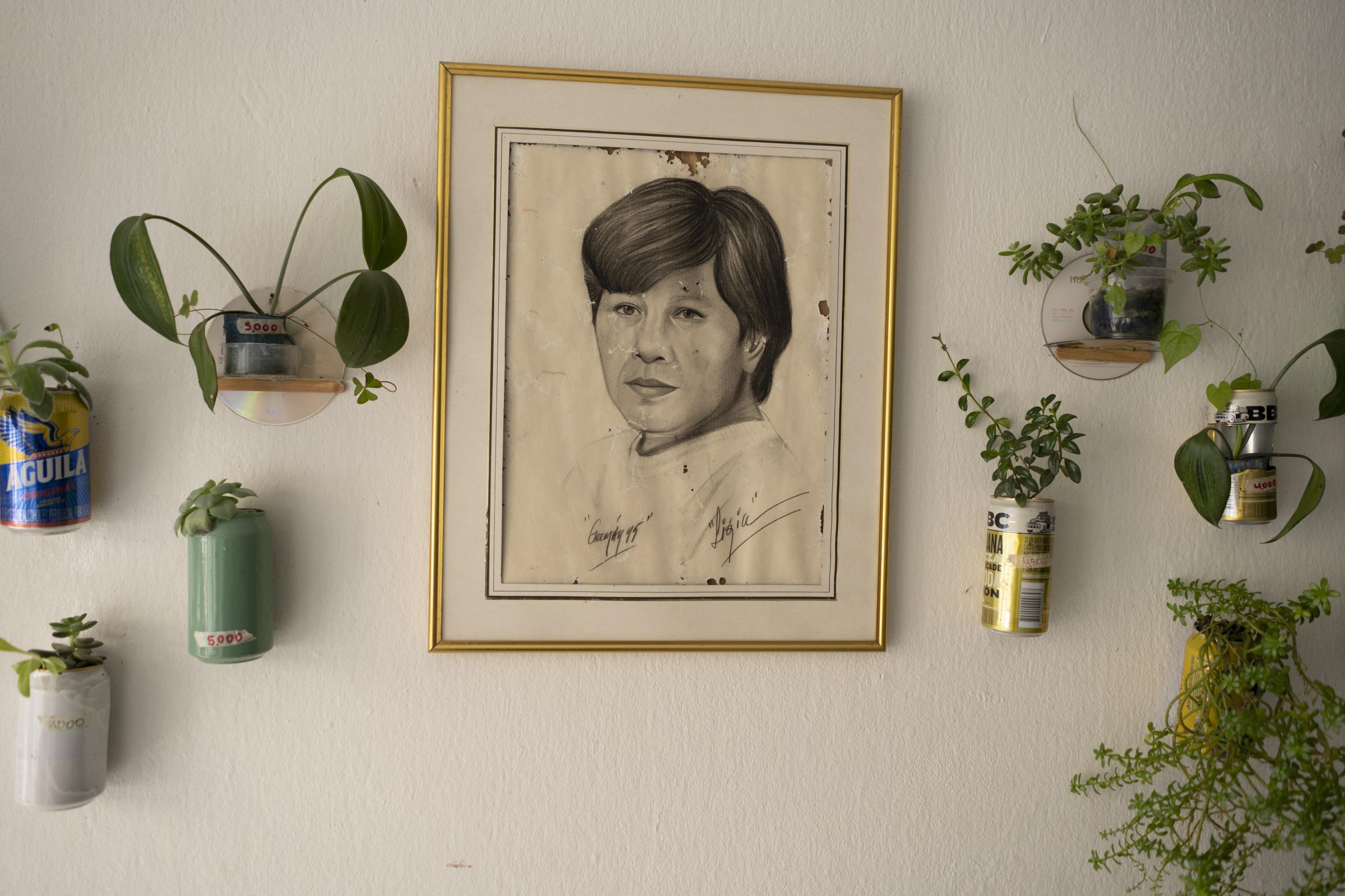 Cleanest neighborhood - 07/03/22. Portrait of Ligia Sanabria next to ornamental plants planted in beer cans in her house....