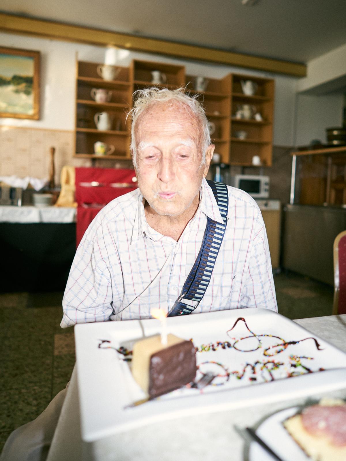 𝐈𝐈. The brief glimpse of a settler's dream - Carlos blowing a candle for his 91st birthday. The cake...