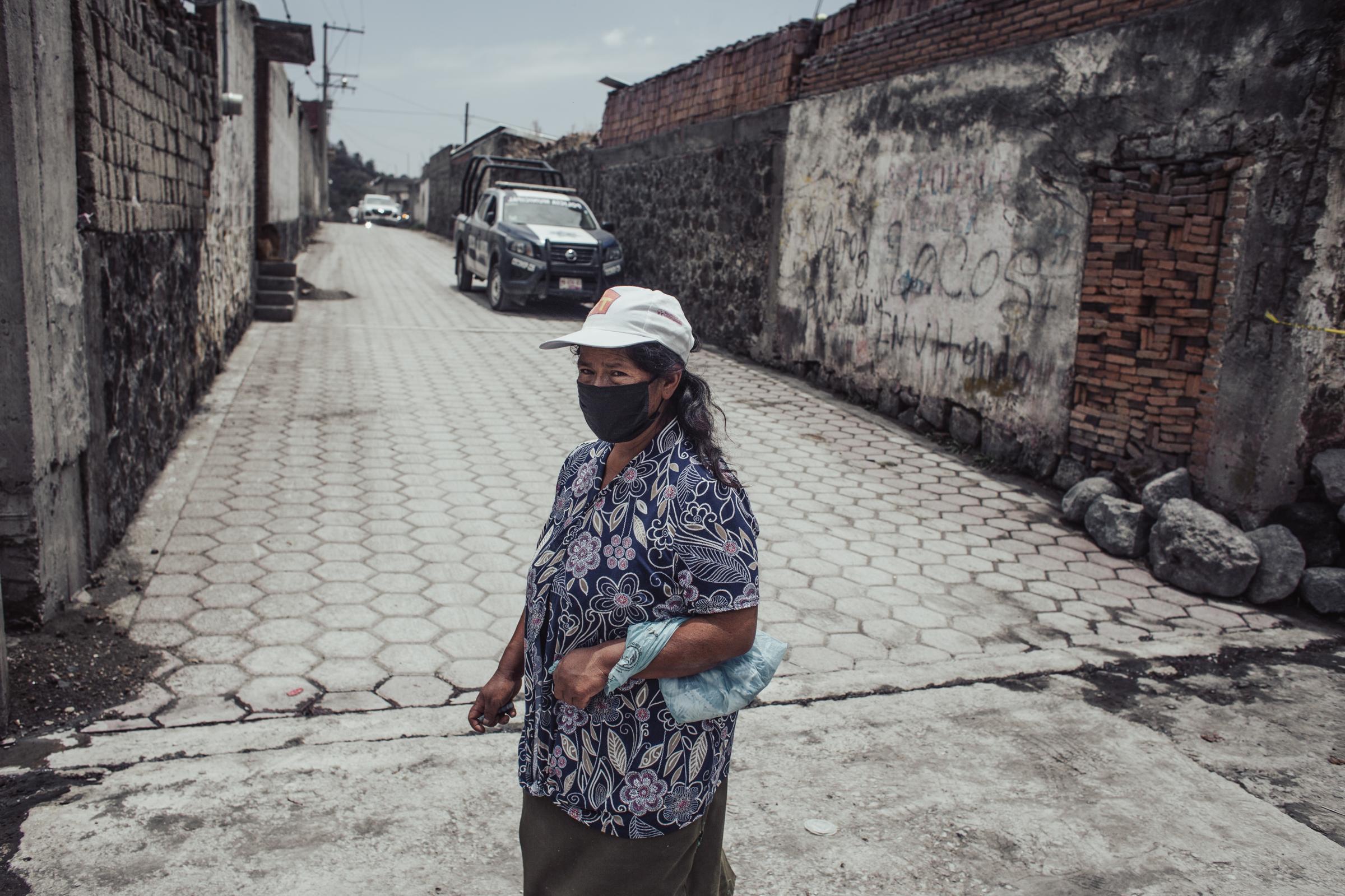 Bloomberg News - Popocatépetl Volcano May 23' - A woman walks through the streets of Santiago...