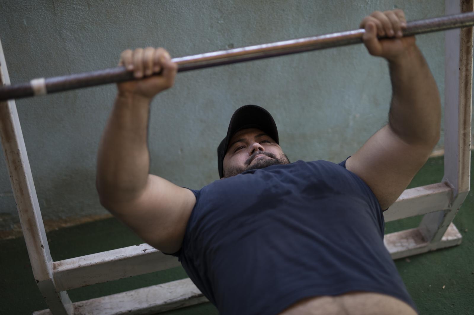 Albania Unemployment - Nori Gllava does a bench press at a closed down gym in...
