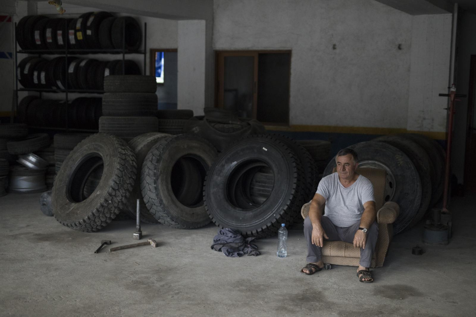 Albania Unemployment - Ahmet Alimerkaj awaits customers at his garage in the...