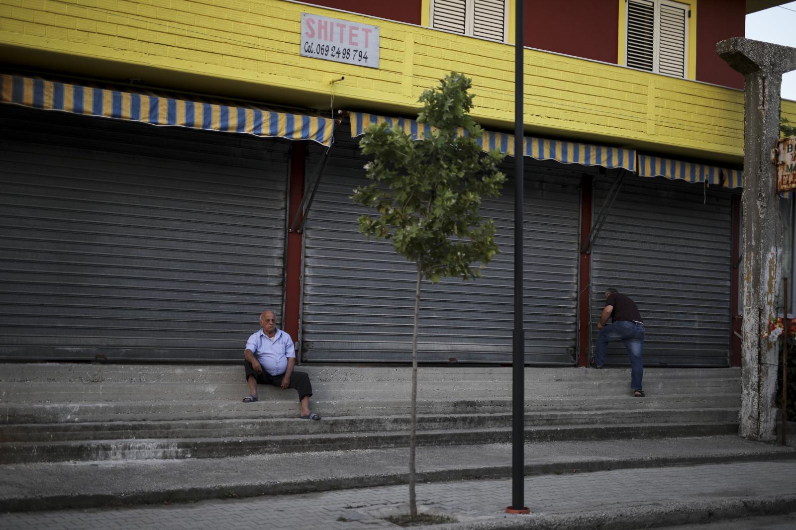 Albania Unemployment - A man sits on the street in the town of Ballsh, July 8,...