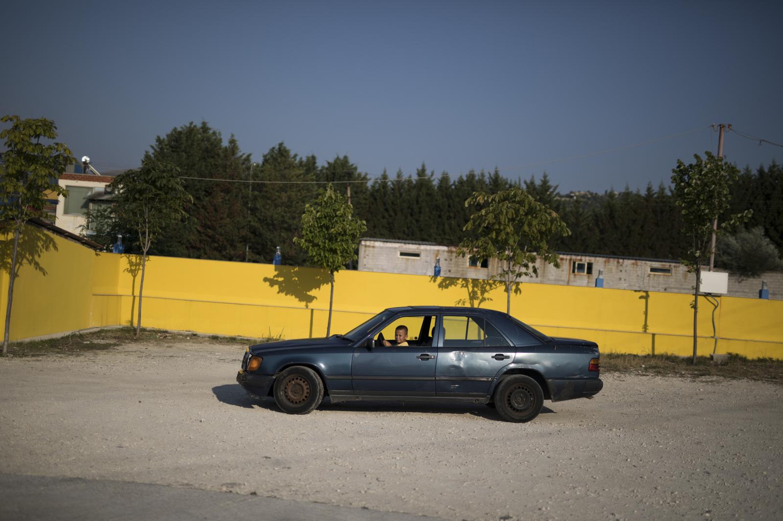 Albania Unemployment - Six-year-old Redi Sakaj drives a car in the parking lot...