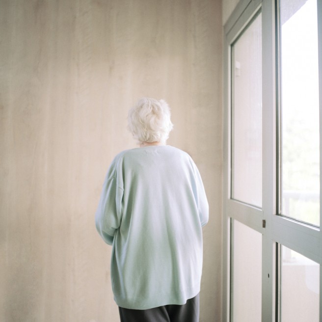Resident fixated in front of a wall, Alzheimerâ€™s ward.
