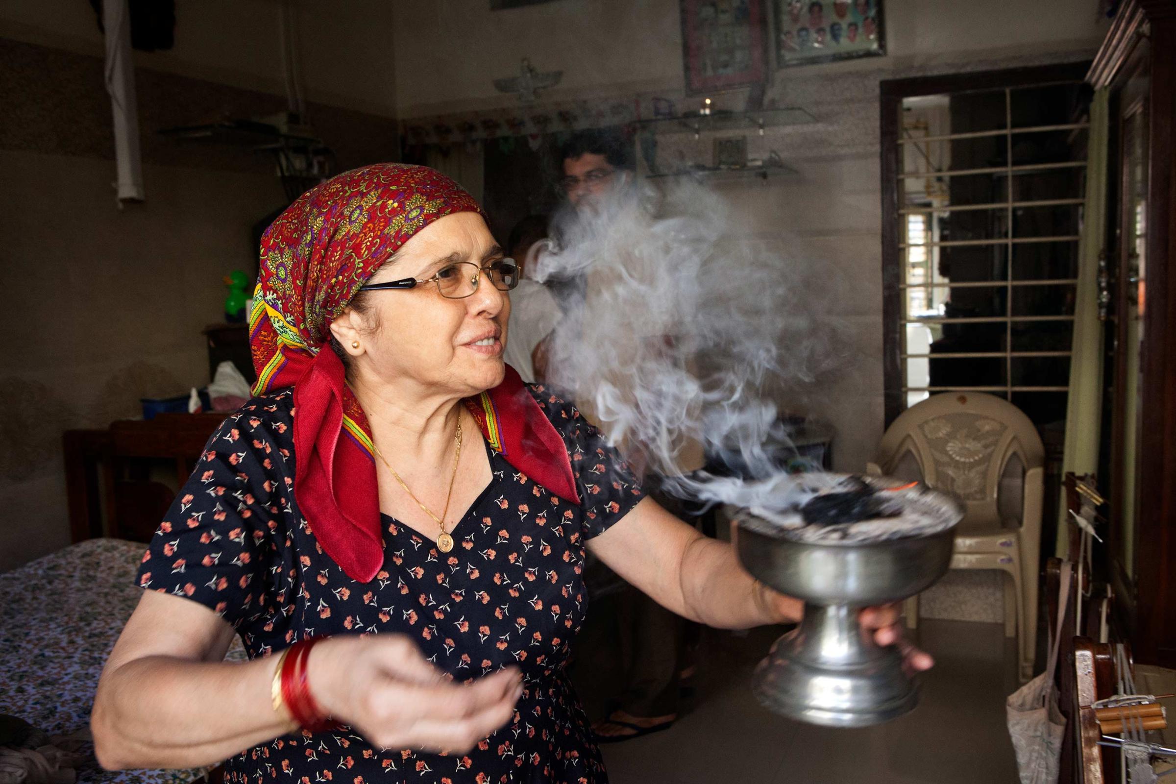 In memory of Greater Iran: The Zoroastrians of Navsari - Mrs Parvin Patel preparing incense at her house in Ava...