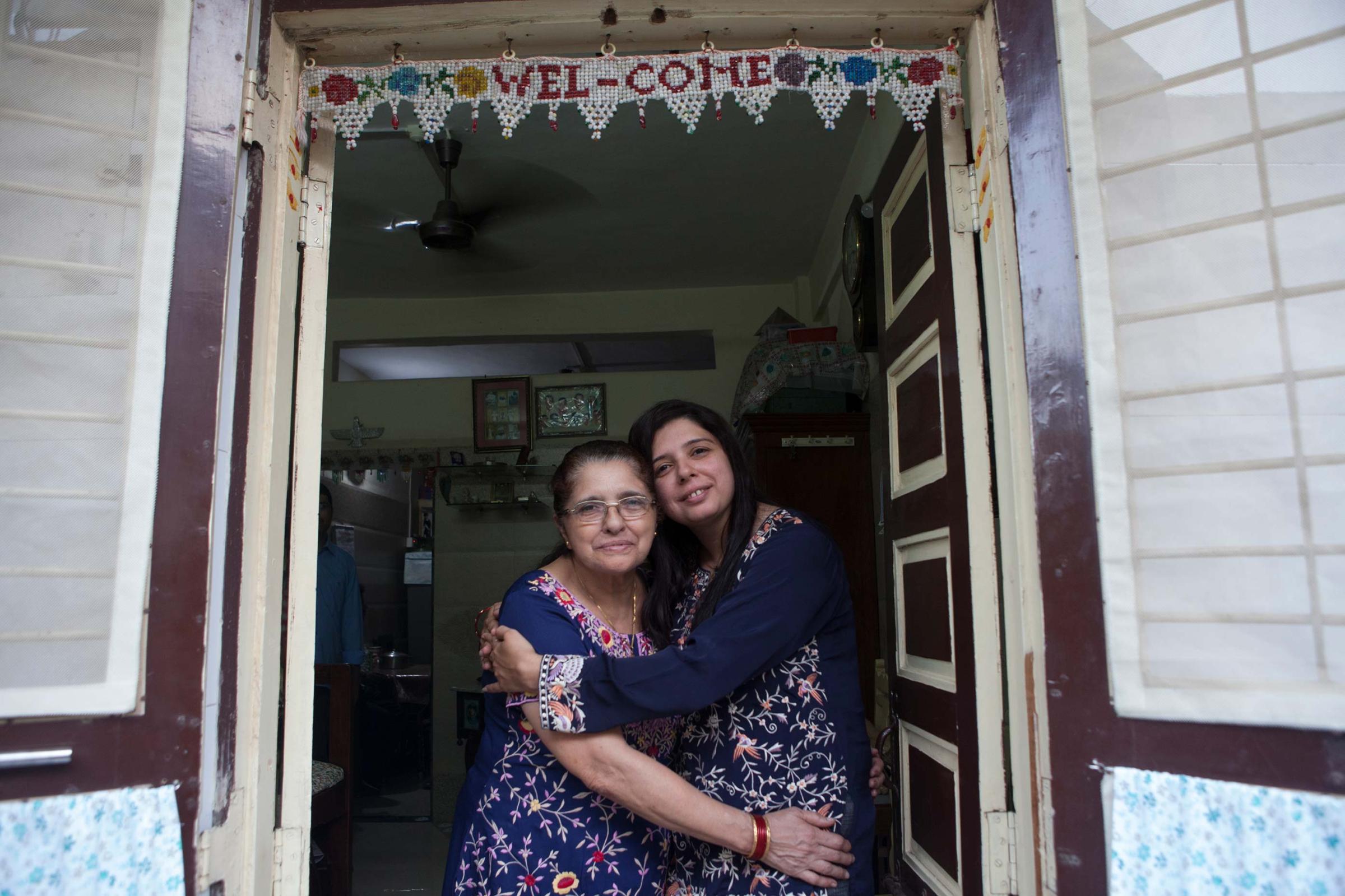 In memory of Greater Iran: The Zoroastrians of Navsari - Dilnaz with her mother Parvin, standing in the doorway of...