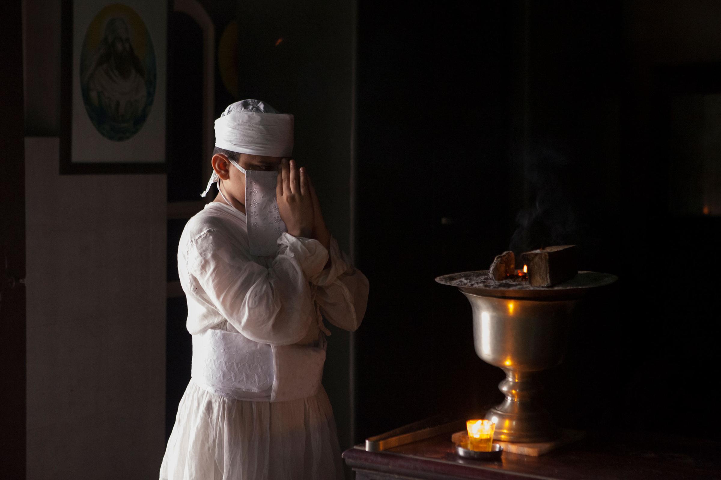 In memory of Greater Iran: The Zoroastrians of Navsari - Mobed Ayush Sharukh Desai offering prayers as part of his...