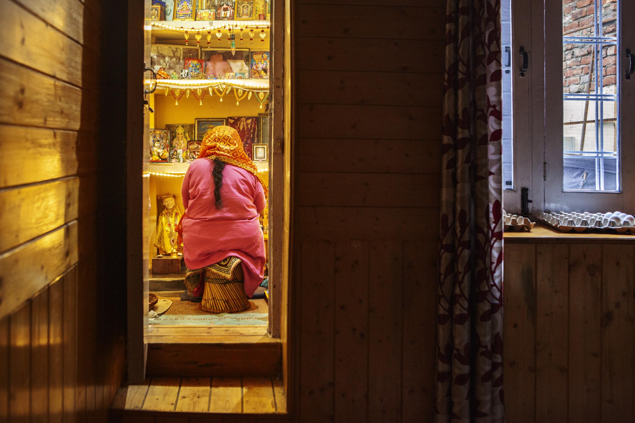 Selective $ympathy  -  Rajini Wanchoo, praying at dusk in her home. She was...