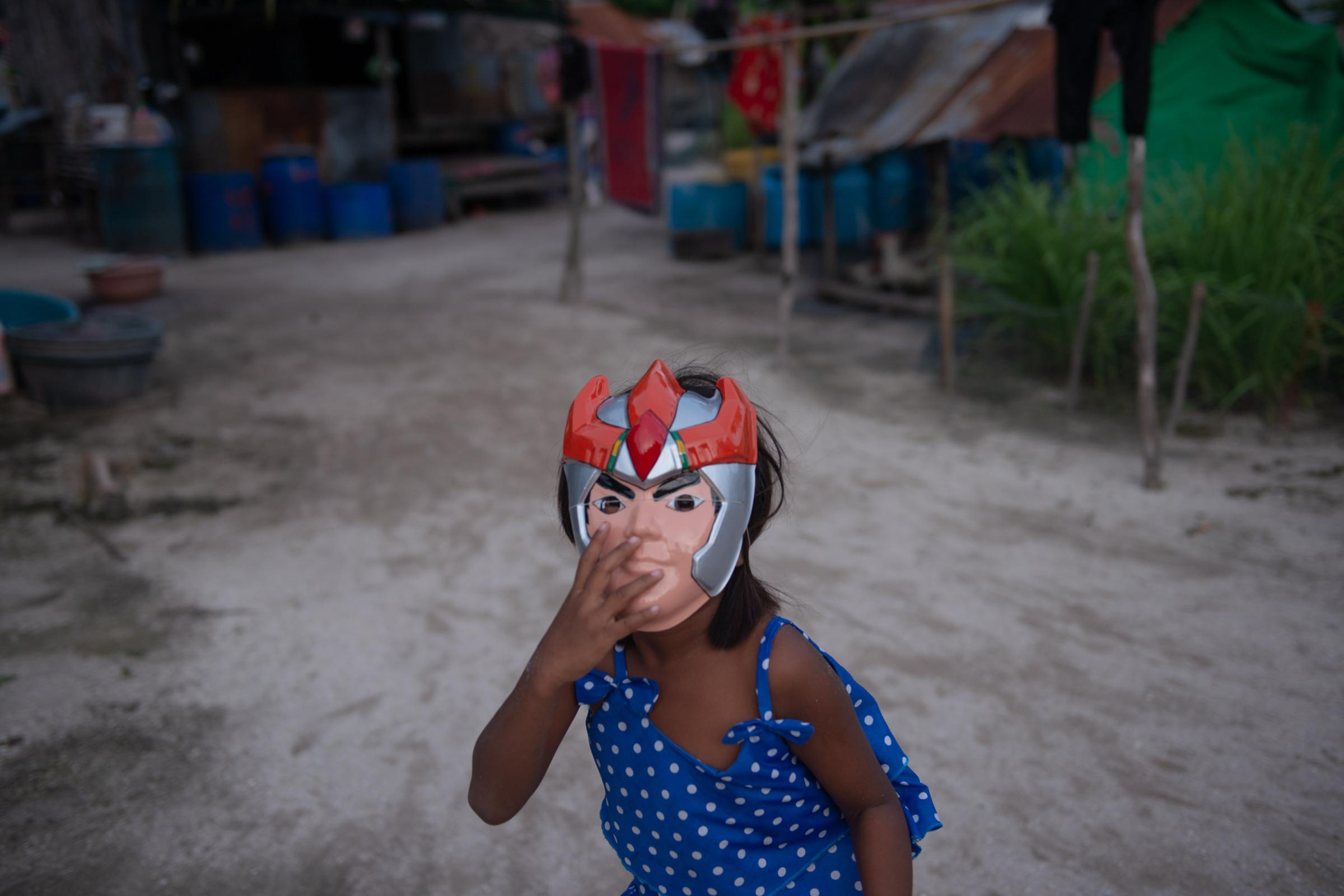Lipe Island - A child wearing an action figure mask in a small gypsy...
