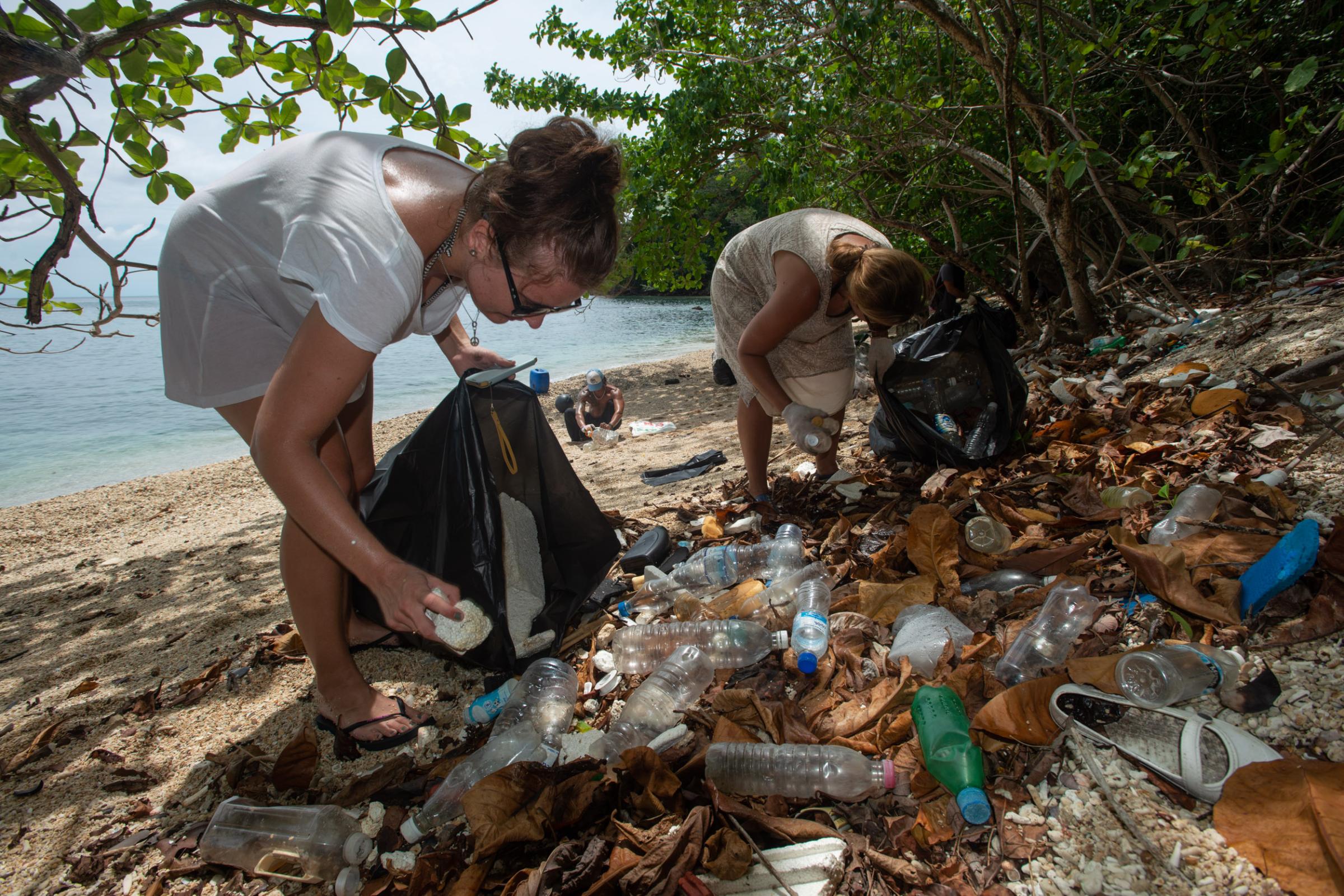 Lipe Island - A small group of tourists, aware of the plastic trash on...