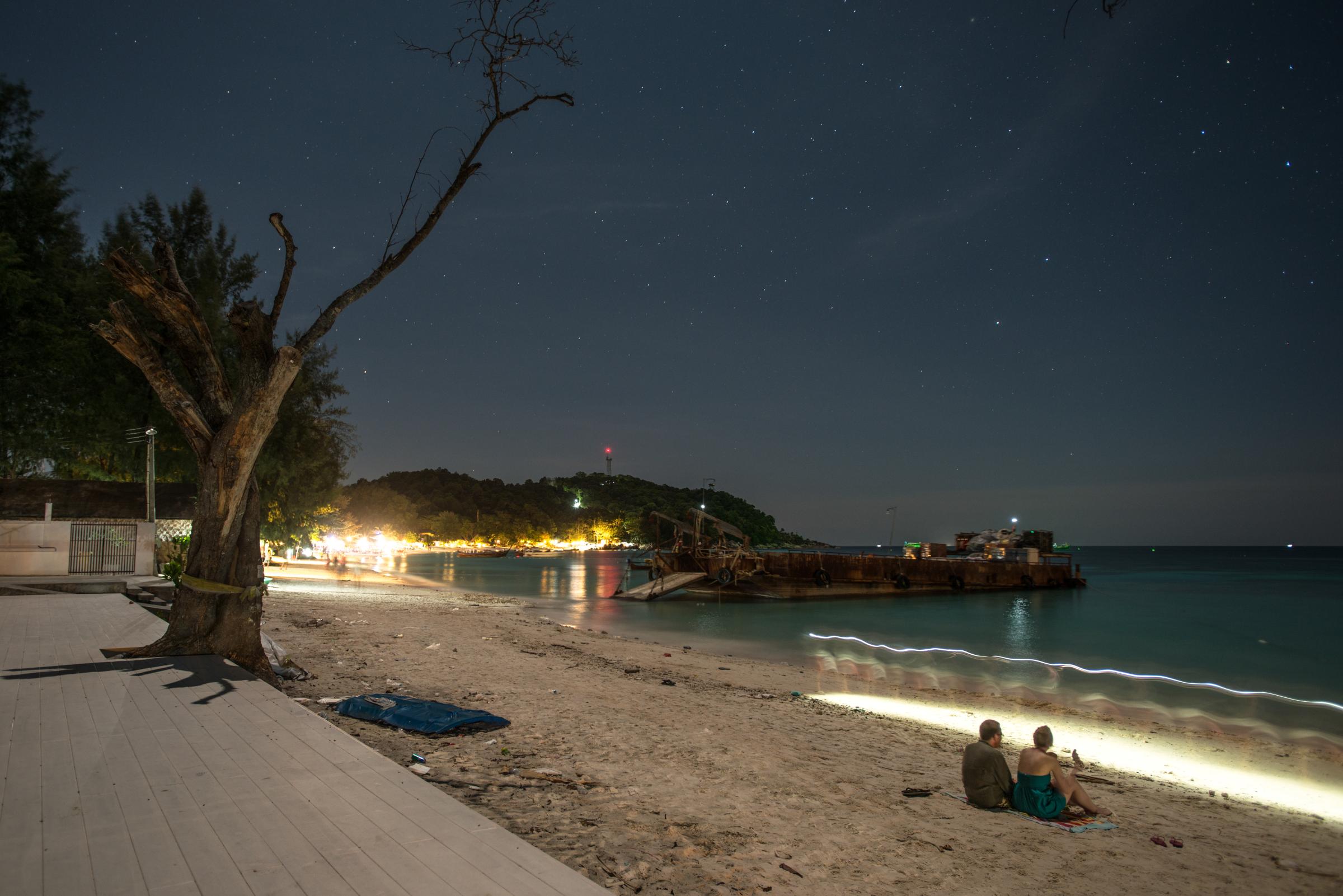 Lipe Island - Tourists relax on the shore, surrounded by the...