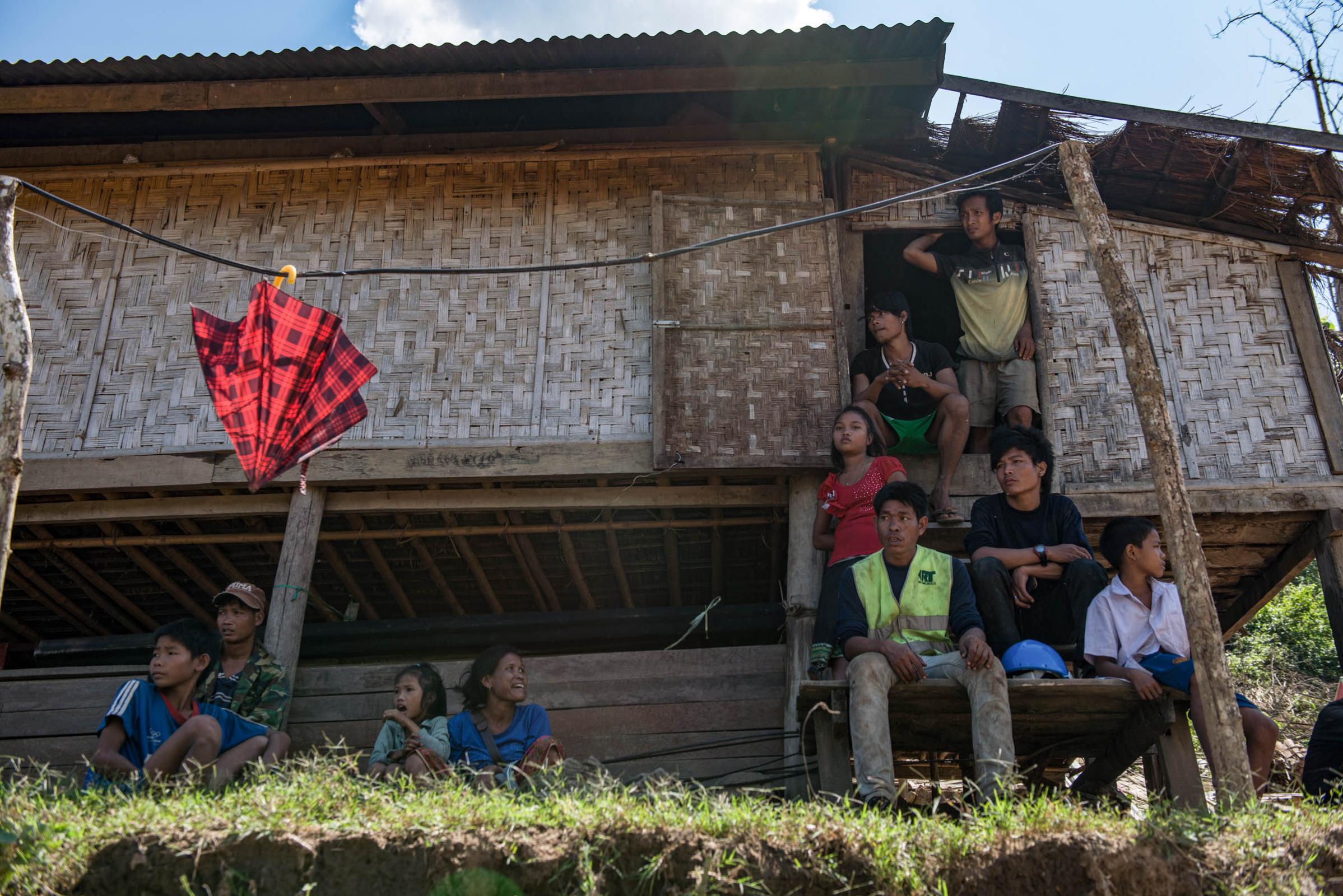 Damming The Mekong River - Villagers take shelter while their village house is being...