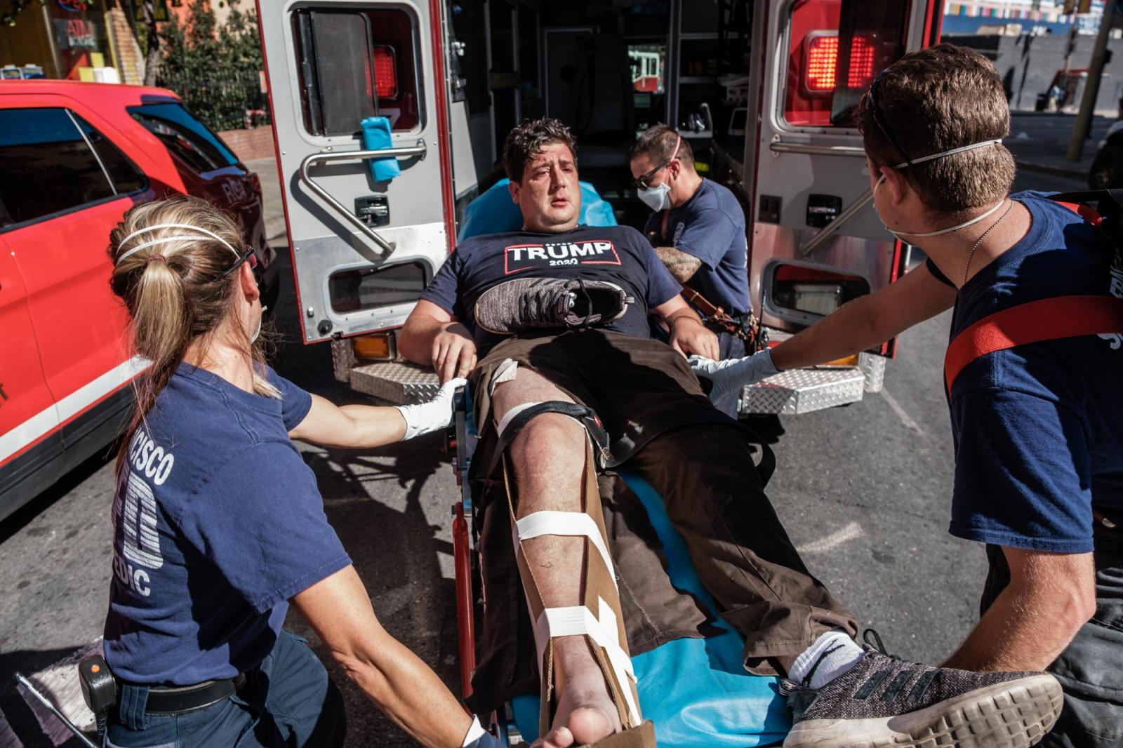Image from NEWS FEATURES - A Trump supporter is wheeled into an ambulance after he...