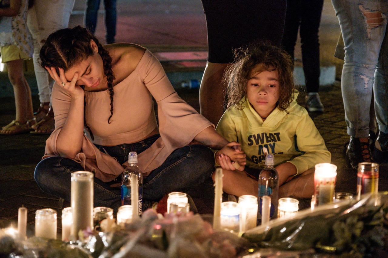 Image from NEWS FEATURES - People gather to mourn, light candles and leave items at...