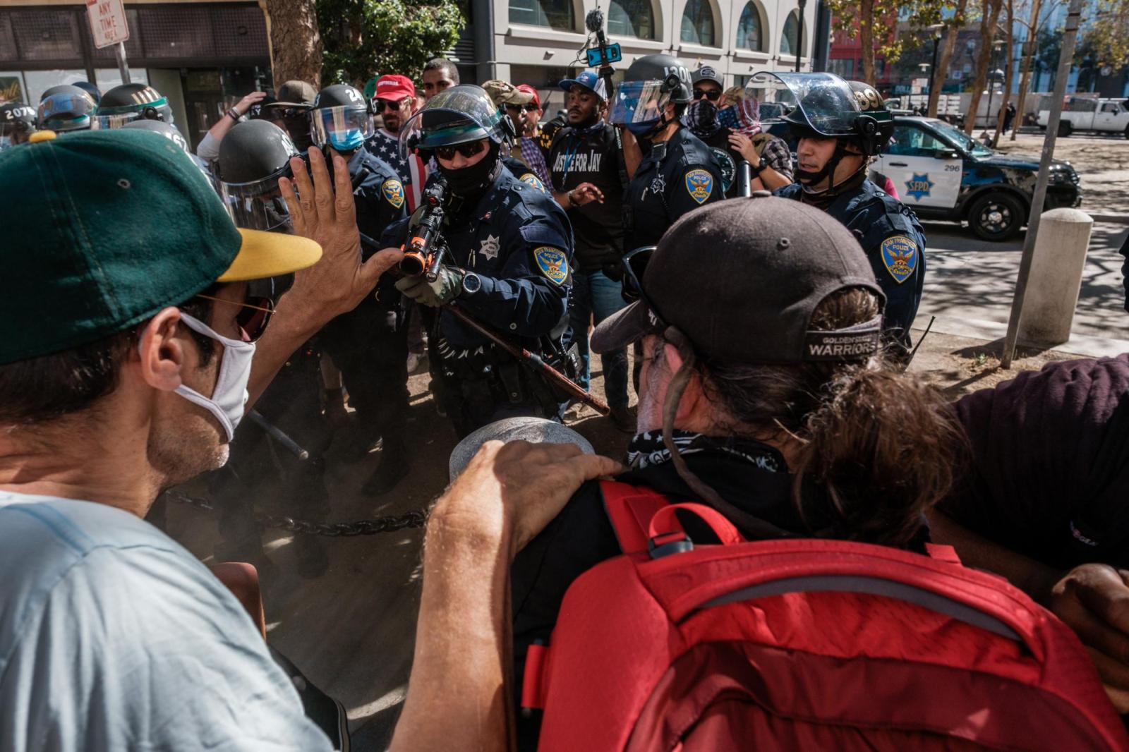 Image from NEWS FEATURES - Police point non lethal guns at counter protesters as...