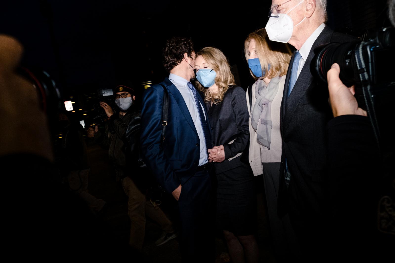 Image from NEWS FEATURES - Elizabeth Holmes, center, pauses with her partner, Billy...