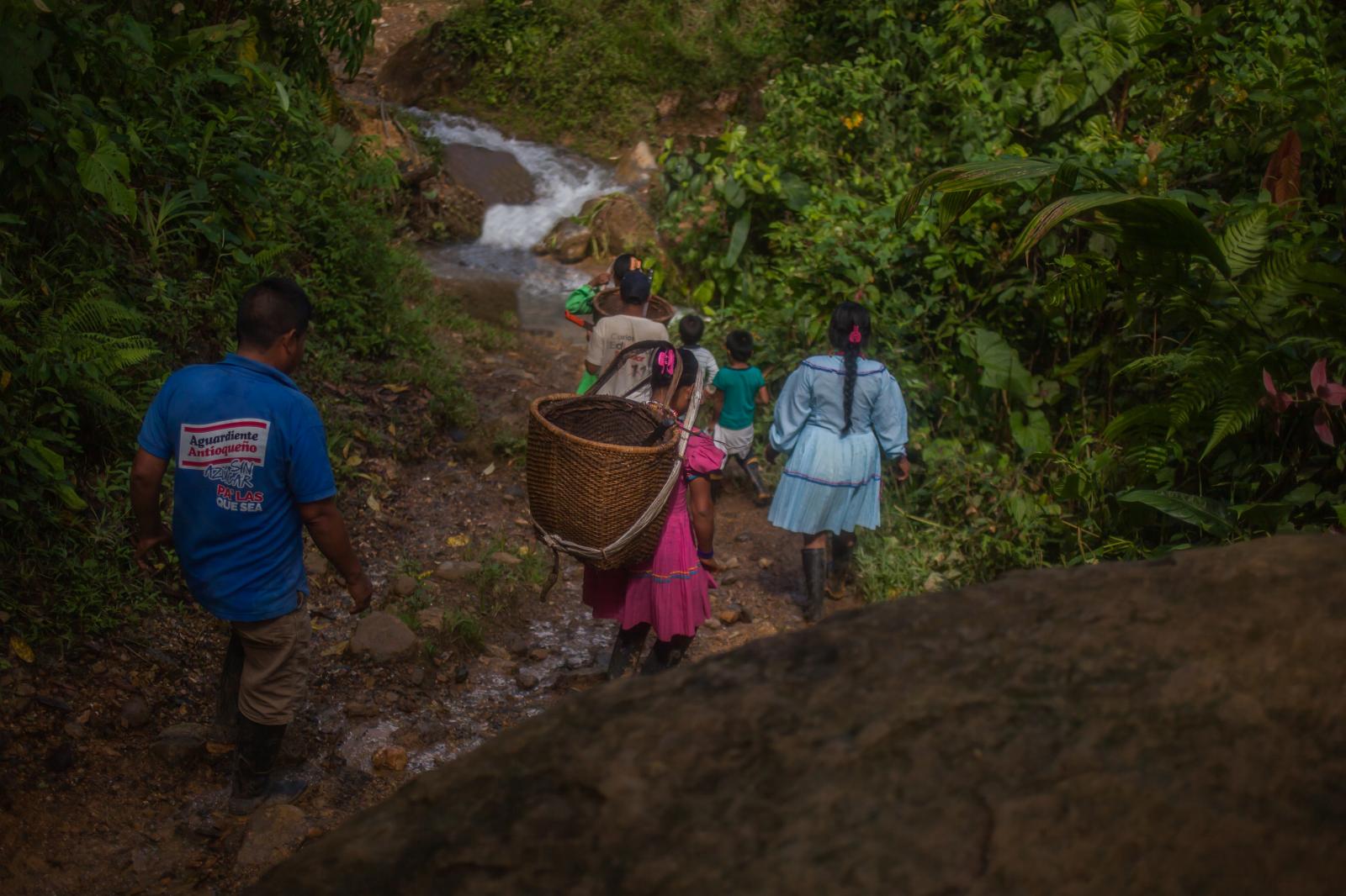 An Embera family walk to the Ke...lking back to their home lands.